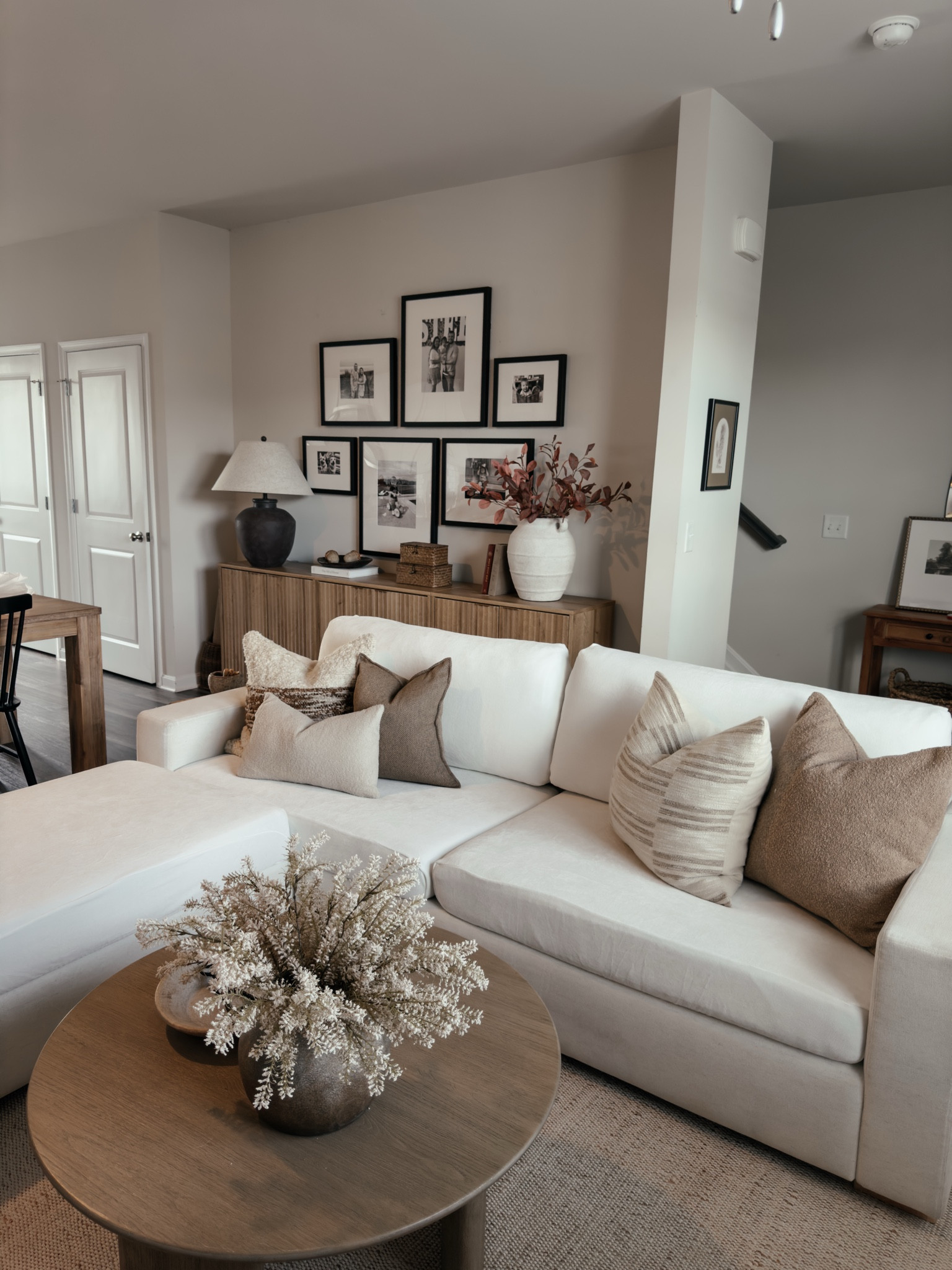 Cozy neutral living room 🤍

White couch, storage ottoman, round coffee table, storage cabinet, large table lamp, gallery wall, throw pillows, couch pillows, sideboard, console table 

#LTKSaleAlert #LTKHome #LTKFindsUnder100