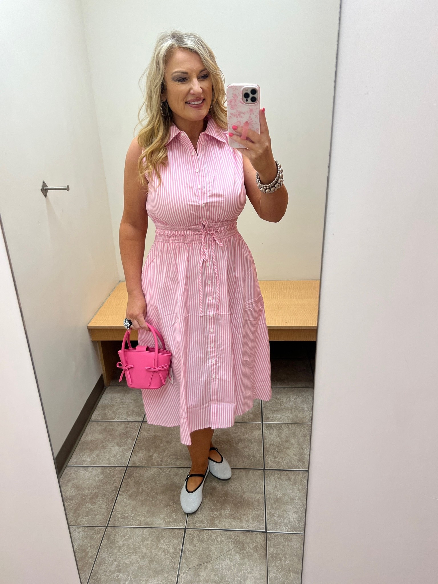 Pink and white striped sleeveless dress, midi length, elastic drawstring waist..  sizes M-XL

I’m wearing a medium. 

Pink bow purse. 

#LTKootd #LTKOver40 #LTKMidsize