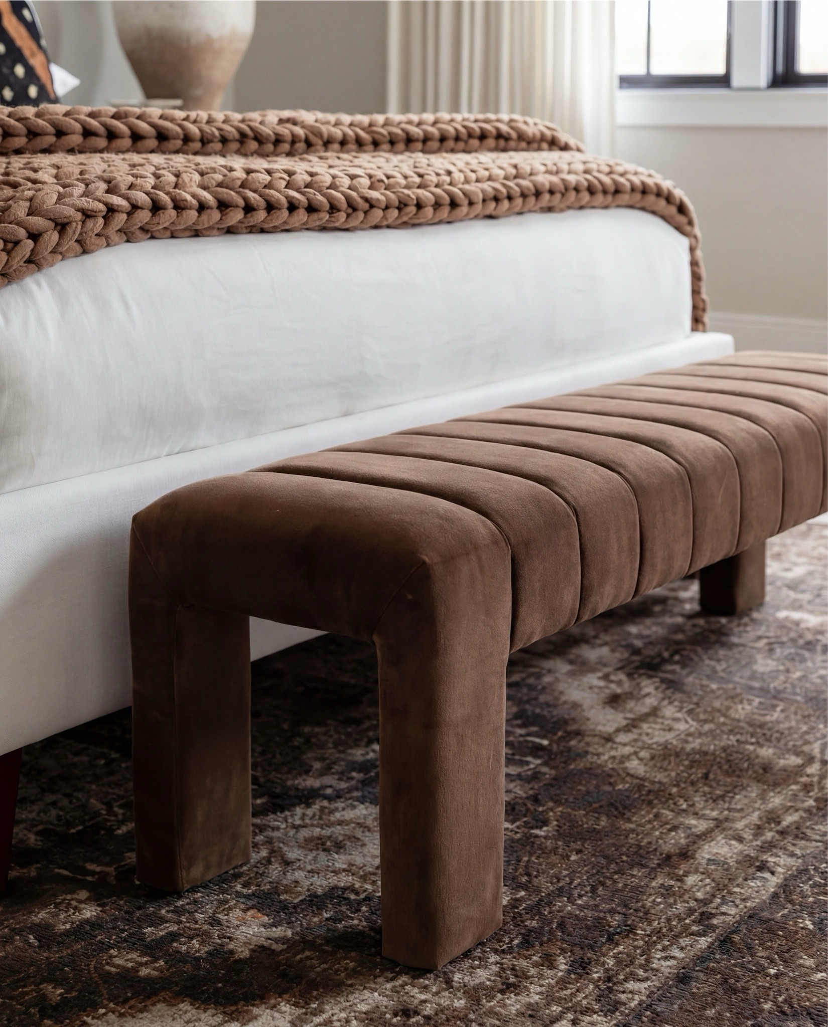 Shop the Look:
• White upholstered wingback bed frame
• White cotton duvet cover + pillow shams
• Textured throw pillows (rust + black patterned)
• Chunky knit throw blanket (warm brown)
• Vintage-style brown area rug
• Dark wood nightstands with brass knobs
• Ceramic table lamp (neutral glaze)
• Brass globe wall sconces
• Framed floral artwork (muted tones)
• Arched brass wall mirrors
• Upholstered bench at foot of bed (camel brown)
• Cream accent chair with wood arms
• Black fluted dresser with brass pulls
• Round black fluted end table 
•Fecor books 
• Large ceramic floor vase (earthy clay tone)
• Decorative wood bead garland
• Sheer white curtain panels
•Round decor bowl tray 
•Wood jewellery box 
•Terracotta bowl 

#LTKHome #LTKSaleAlert