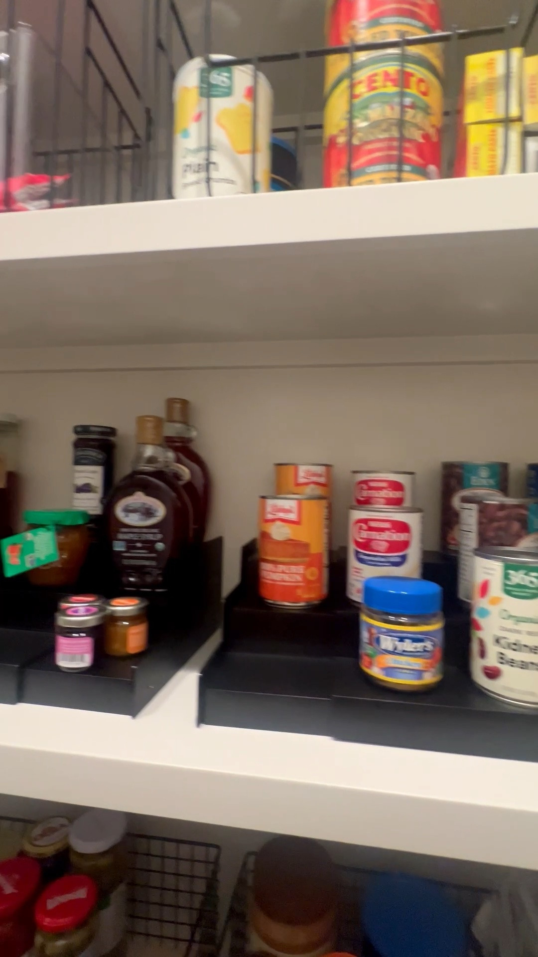 Pantry shelves are so much easier to use when you can actually see what’s hiding in the back.

These black expandable 3 tier shelf risers are one of those simple products that make cans, jars, syrups, and smaller pantry items feel way less chaotic. I like them because they adjust to the shelf width and create height without needing a full pantry makeover.

I also used metal pantry baskets to corral the overflow and keep categories together, because loose pantry items love to wander off and start their own little clutter community.

Linked the shelf risers and a few of my favorite pantry baskets here.

#LTKHome #LTKfoodie #LTKmomlife