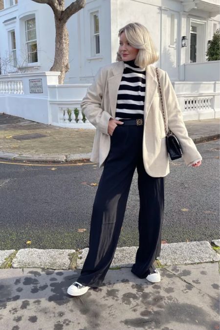 Chic smart casual outfit for winter. Perfect for layering. Striped black and white jumper, wool blend cream blazer, wide leg black trousers, Loewe belt & comme des garçons converse

#LTKstyletip #LTKSeasonal #LTKeurope