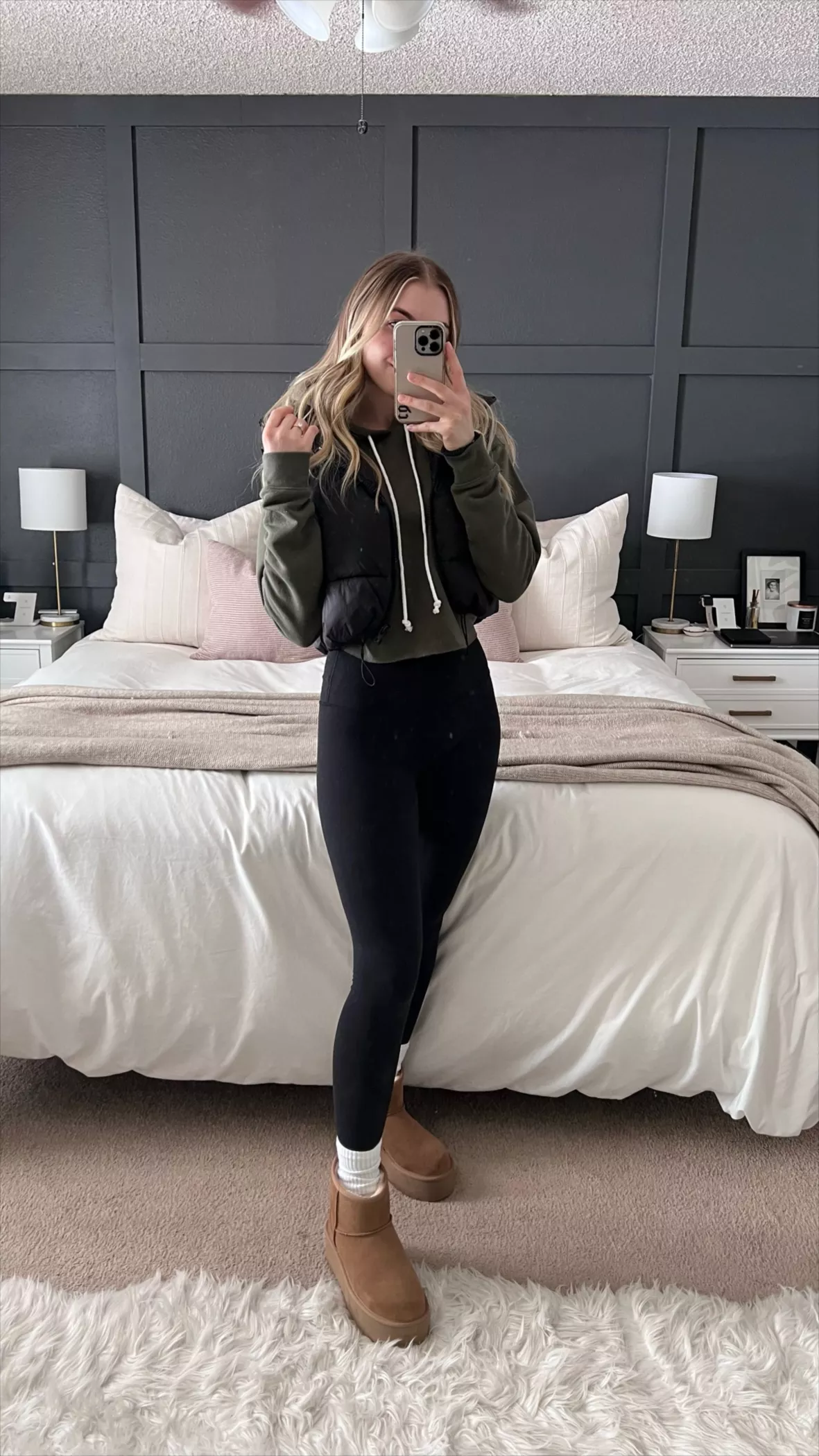 blonde woman wearing gray hooded jacket black leggings brown boots