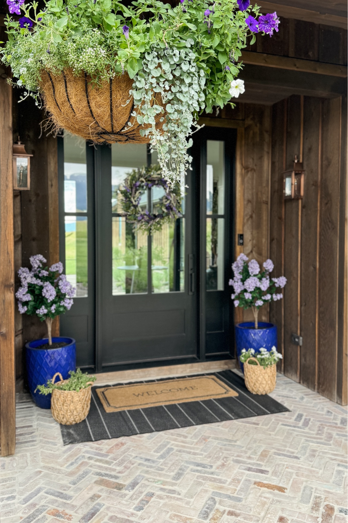 Our entryway with lilac bushes, wreaths, and hanging baskets!

#LTKHome