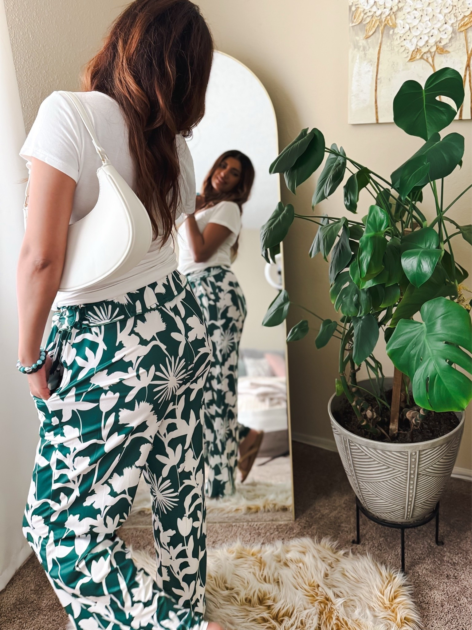 Statement pants are the moment 🌿✨ These wide leg pants are the perfect summer wardrobe piece to dress up with heels or keep casual with sneakers or sandals. Lightweight, comfy, flattering, and such an effortless chic vibe for brunch, vacation, errands, or date night. Paired with a simple white tee and accessories for that elevated everyday look 🤍 #LTKStyleTip
Top size S
Pants size S
Sandals size 8
Etsy: bracelets 10% off code SALE10

wide leg pants, summer outfit, tropical print pants, statement pants, vacation outfit, resort wear, casual chic outfit, elevated basics, green floral pants, summer fashion, comfy chic style, effortless outfit, everyday style, brunch outfit, lightweight pants, neutral outfit ideas, trendy summer look, women’s fashion, flowy pants outfit, capsule wardrobe, dress up or down outfit, stylish vacation look, resort chic, casual elegant outfit, fashion inspo, ootd style, spring summer trends, white shoulder bag outfit, relaxed fit pants, chic everyday wear

#LTKfitnessgoals #LTKootd #LTKmomlife