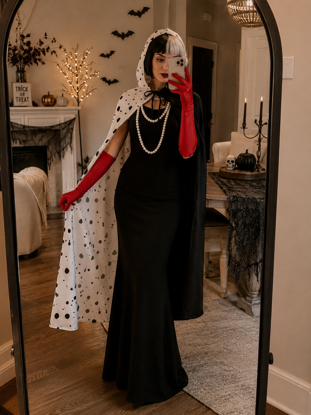 This Cruella-inspired Halloween look is giving old-school glam 🖤❤️ The long black gown, statement spotted cape, red gloves, pearls, and black-and-white hair make it feel so polished and dramatic. Such a good costume for a Halloween party or a cute getting-ready mirror pic before heading out. ✨

#CruellaCostume #HalloweenCostume #HalloweenGlam #HalloweenOutfitIdeas #HalloweenPartyLook #CostumeInspo #SpookySeason #HalloweenFashion #OctoberStyle #Halloween2026 

 #LTKootd #LTKSeasonal #LTKU