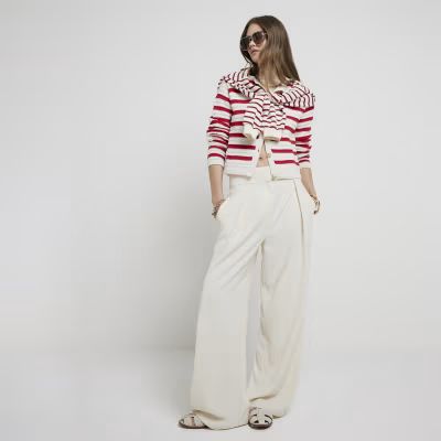 Cream pleated wide leg trousers | River Island (UK & IE)
