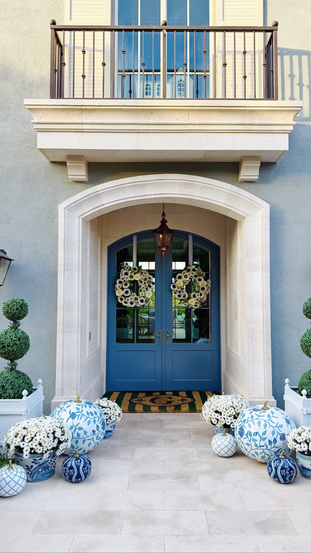 Simple blue and white sunflower wreath fall porch. These French planters and faux boxwood look good year round. The blue and white pumpkins are so fun for fall! The faux zinnias look incredibly realistic!

#LTKHome #LTKSeasonal