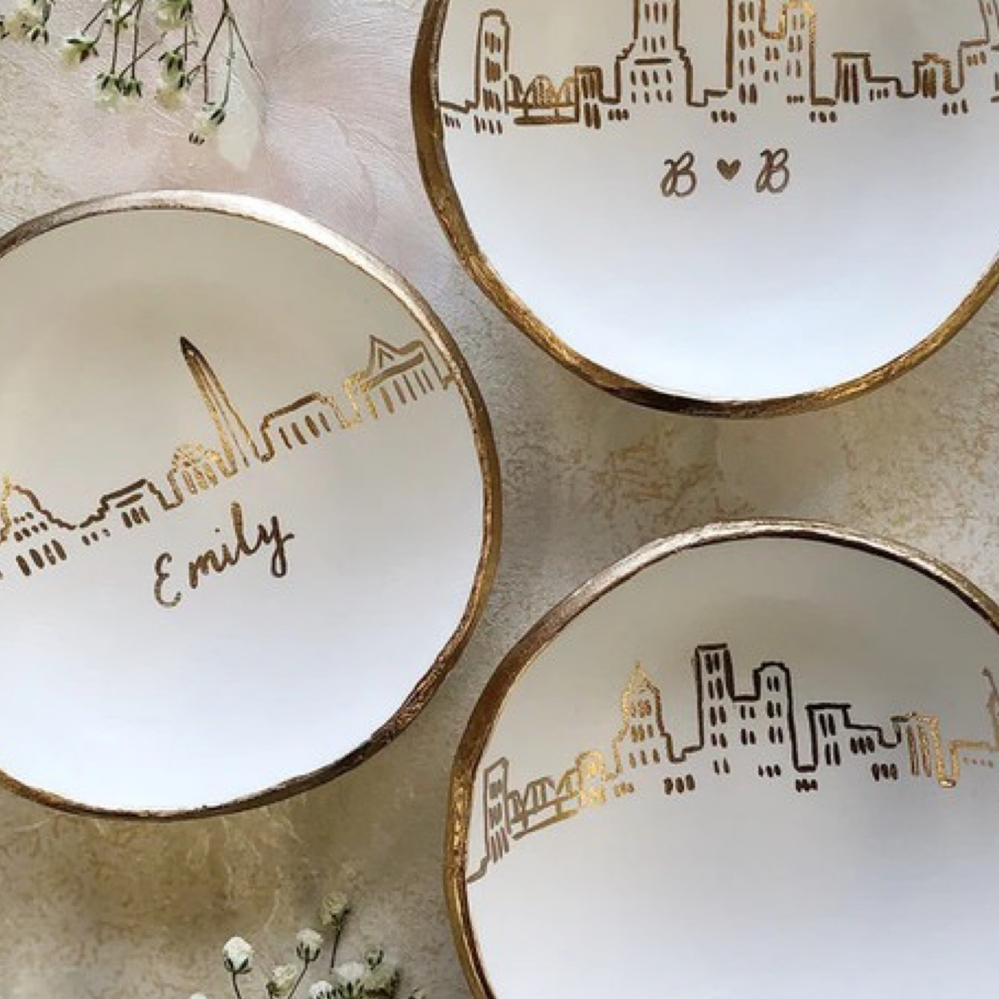 Interior designer gift guide. Etsy's Pick – the Personalized Skyline Jewelry Dish is a truly special and unique creation. Back in 2014, the idea behind this dish was to offer something personal, affordable, and completely distinctive. These jewelry dishes are not just functional but also carry individual meaning for each person who orders one.

What sets these dishes apart is their elegant and minimalist design. They're more than just a place to hold your rings or trinkets; they're a reflection of your personal story. While similar items have since appeared, it's important to recognize and appreciate the original concept.

Here are a couple of important details about these dishes:
- They are not made of ceramic but are lightweight and slightly pliable. This unique construction makes them highly durable and less prone to shattering if accidentally dropped.
- Each dish is meticulously crafted in the studio. They are molded, stamped, painted, and sealed by hand. This delicate hand-crafted process ensures that every dish is one of a kind, with its own unique character.

So, whether you're looking for a personalized gift, an anniversary keepsake, or a unique wedding gift, this Personalized Skyline Jewelry Dish is a wonderful choice. It's a piece of art with a personal touch, and it's ready to hold your cherished items in style. 🏙️💍

#LTKbeauty #LTKGiftGuide #LTKworkwear