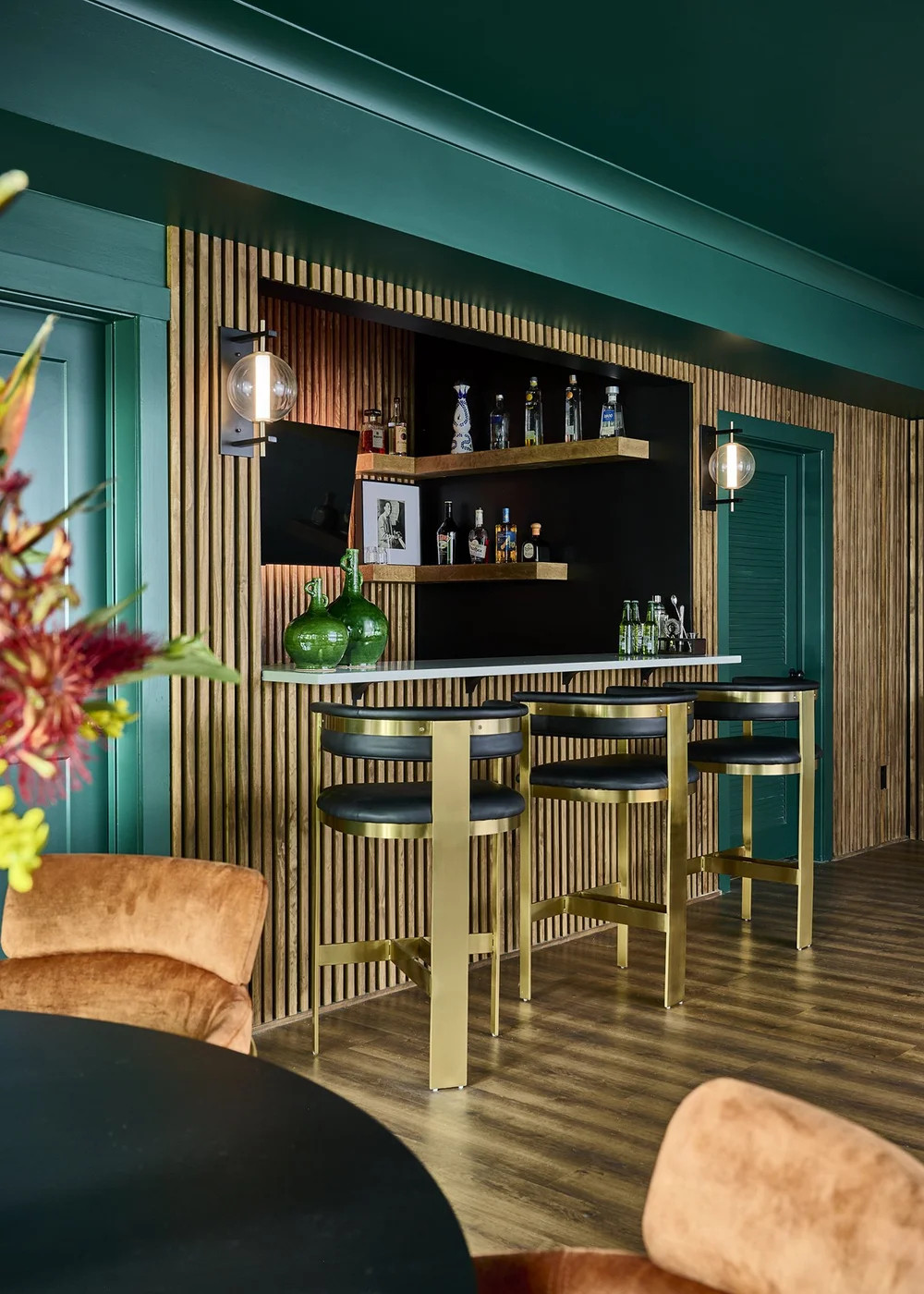 This bar moment from Project Meet Me in Accra will always be one of my favorites. 🤍
Moody green walls, warm wood slats, brass details, and layered styling came together to create a space that feels intimate, elevated, and meant for lingering.

I wanted this area to feel like a destination inside the home — a place for conversation, connection, and a good drink at the end of the day. Proof that bold design can still feel welcoming and soulful when every detail is intentional.

#LTKHome #LTKDesign #BLBDesign #MeetMeInAccra #HomeBarDesign #MoodyInteriors #ModernEclectic #StatementDesign #InteriorDesignInspo #LayeredLiving 

 #LTKHome