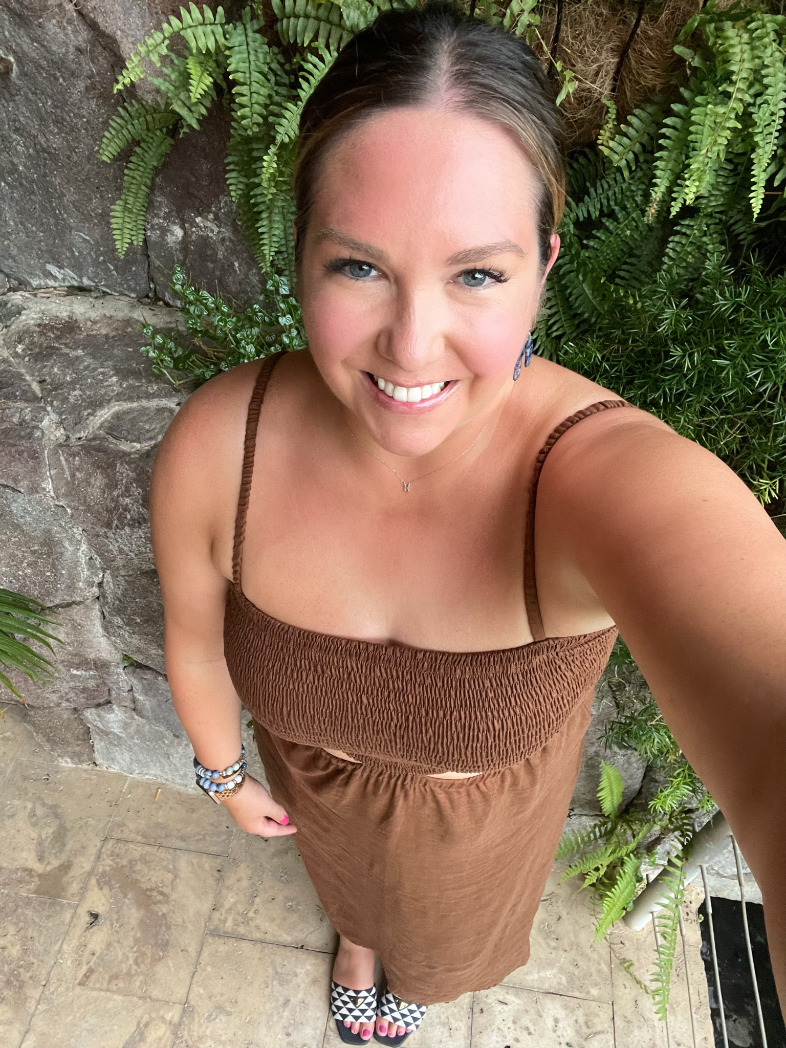 Another outfit from our trip. This dress is nothing like I usually wear but I loved the subtle cutouts. I styled it with my fun navy and white print shoes to add a little interest. I kept all my accessories blue to tie it together. My earrings are currently on sale too!

#LTKSeasonal #LTKtravel #LTKshoecrush