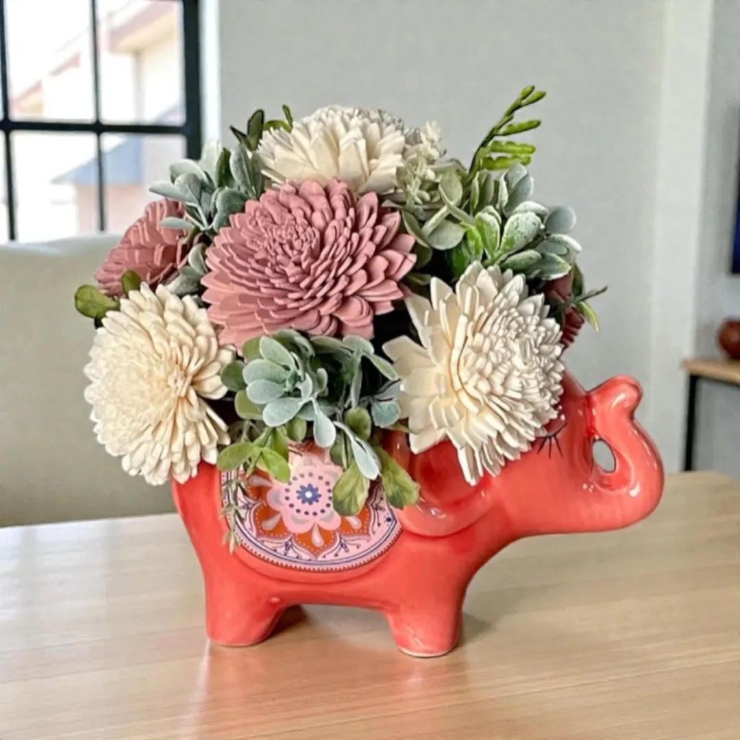 This playful elephant ceramic planter holds a sweet 6” arrangement of hand-dyed sola wood flowers for a fun and whimsical décor piece. Crafted from natural tapioca root, each bloom is carefully dyed, fluffed, and arranged to create a charming floral display that lasts. The pink tones and boho style make it a perfect accent for shelves, desks, or a thoughtful gift for someone who loves unique handmade décor. 🐘🌸 #ltkhome #ltkfinds #etsyfinds #bohodecor #homeaccent #giftideas

#LTKSeasonal #LTKHome