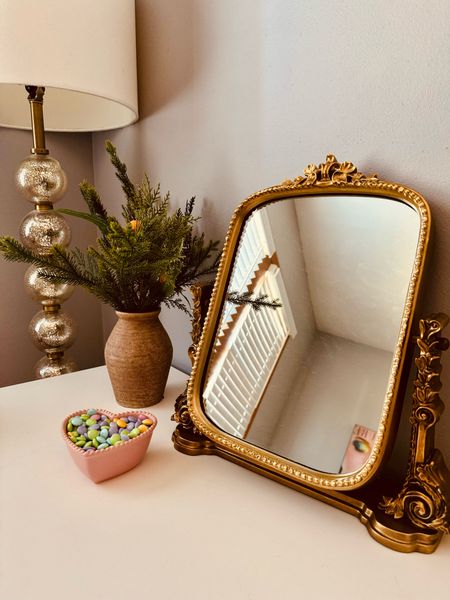 Styled bedroom nook ✨🌸 • Anthropologie Gleaming Primrose vanity mirror, monogram trinket dish, white floor lamp, Easter blend m&m’s 

#LTKstyletip #LTKhome #LTKSeasonal