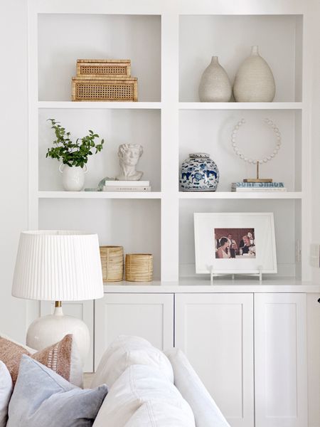 Bookshelf styling in the living room, with home decor from Amazon- woven baskets vase jar ginger chic coastal art holder frame boxes rattan cane 

#LTKstyletip #LTKsalealert #LTKhome