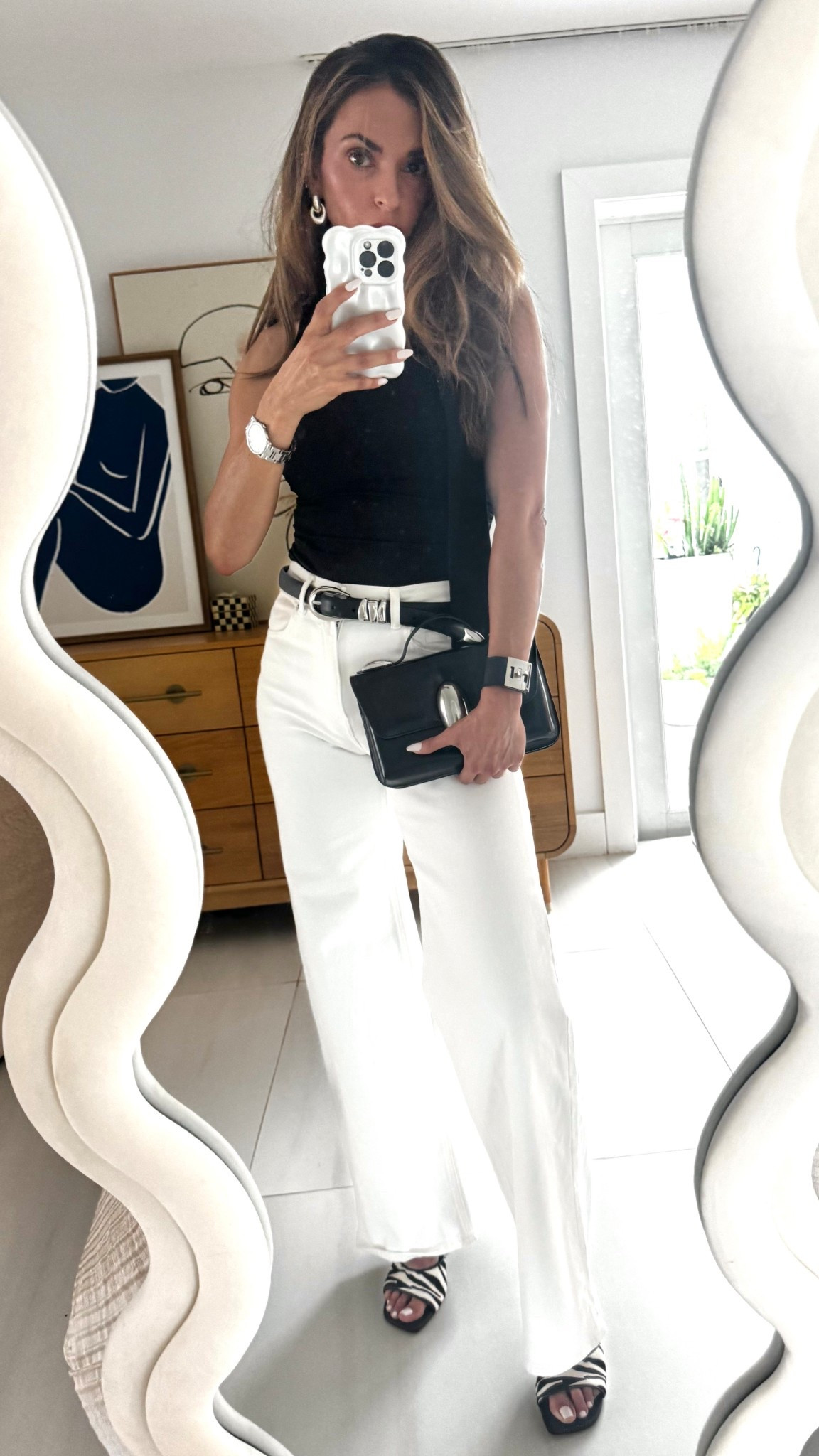 Chic monochrome moment 🖤🤍
Styled a scarf top with high-rise white denim for a sleek and summer-ready look.

The black belt adds contrast and structure, while zebra heel sandals bring in a bold pop of print.
Finished it with a statement black clutch for a modern edge.

Everything is linked below for your next elevated daytime outfit!

#LTKStyleTip #LTKTravel #LTKSummerEdit