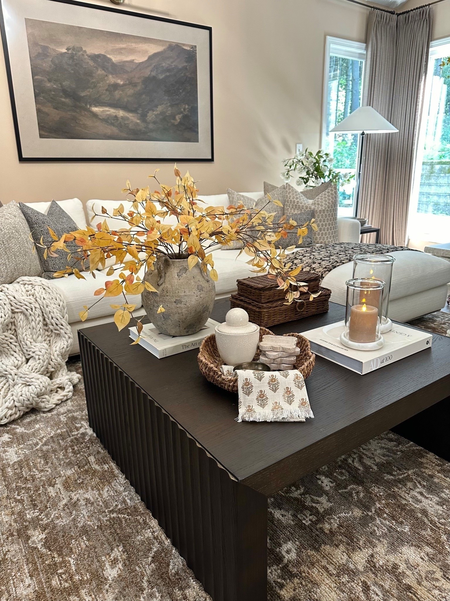 Coffee Table Styling 🍂
Follow @farmtotablecreations on Instagram for cozy, elevated styling.

A few warm-toned accents go a long way in setting the tone for fall. I layered a chunky knit throw, textured pillows, a rustic vessel with golden fall stems, and cozy candlelight for that collected and relaxed feel. A shallow basket, ceramic details, and a patterned linen napkin tie it all together with just the right amount of texture and charm.

#coffeetablestyling #fallhomedecor #vessels #fallstems #textureddecor #neutralhome #livingroom #pillows #coffeetable #coffeetabledecor #falldecor

#LTKHome #LTKSaleAlert #LTKSeasonal