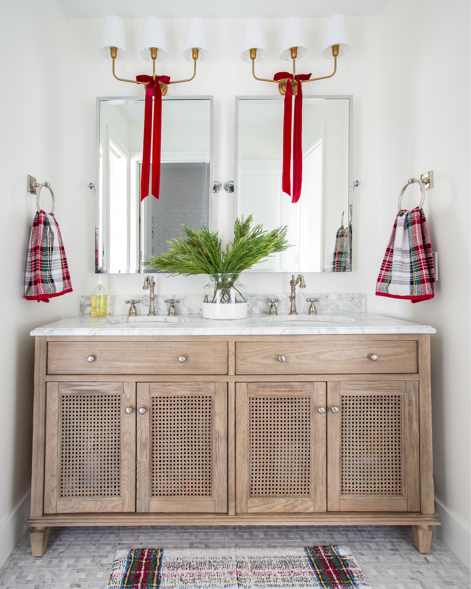 Our guest bathroom decorated for Christmas in Omaha! Includes our wood and cane vanity with marble countertop, silver framed mirrors, red velvet ribbon, faux holiday greenery, and Stewart plaid towels and bath mat!
.
#ltkholiday #ltkhome #ltkseasonal #ltksalealert #ltkfindsunder50 #ltkfindsunder100 #ltkstyletip Christmas bathroom decor, cozy Christmas decorating

#LTKHome #LTKSaleAlert #LTKHoliday