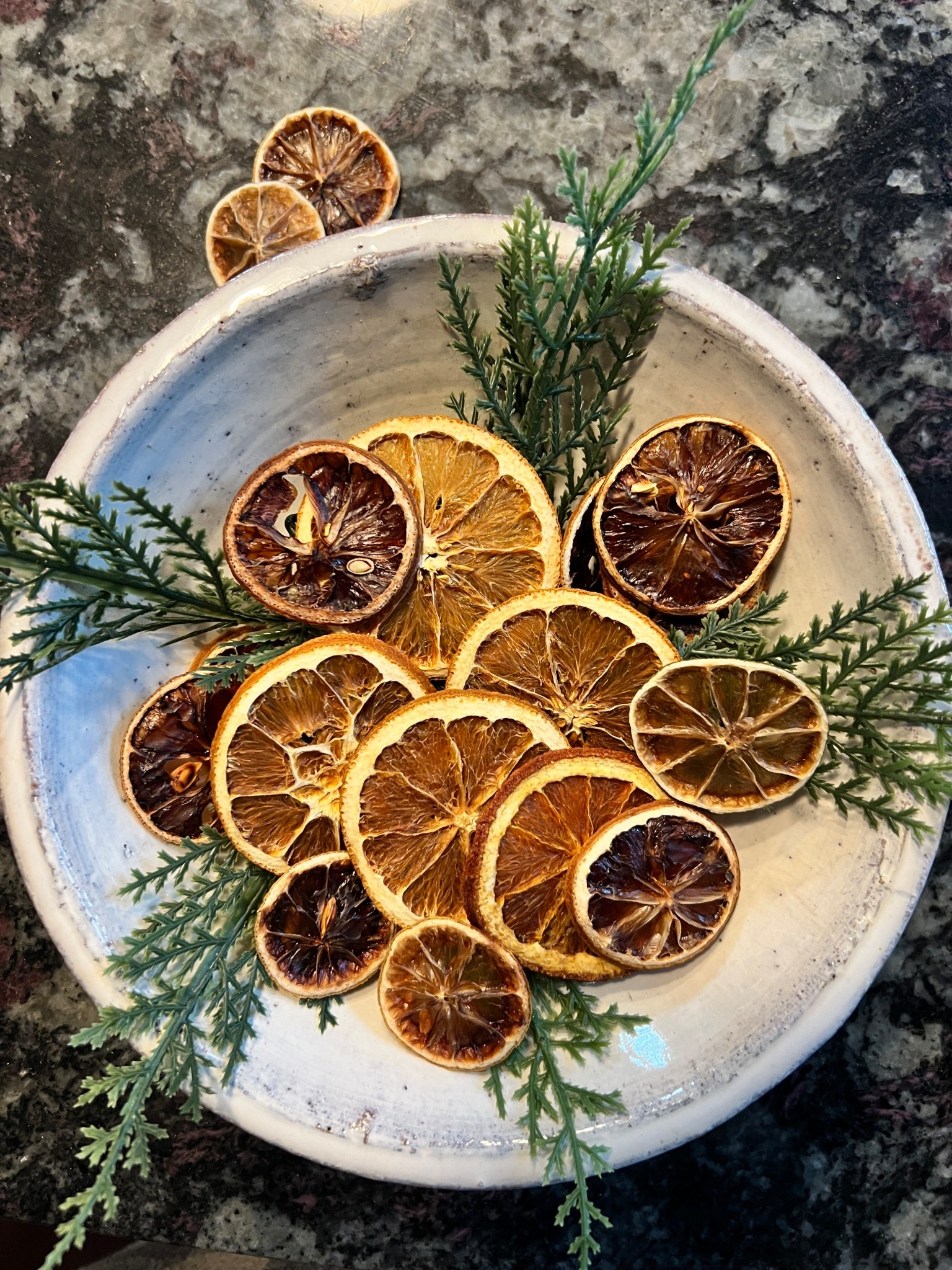 Have you oven dried your own citrus slices? 🍊🍋🍋‍🟩 Would you?

Want to dry your own?! Comment citrus for recipe we used! 

Here is the recipe we used - perfect for a day you are hanging around the house watching Christmas movies! 
Preheat oven to 200 degrees. Line a baking sheet with parchment paper. Top with thin orange, lemon, & lime slices in a single layer. Bake until the peels are dry and the flesh is translucent, about 2 1/2 hours.

We were inspired by our trip to Chicago and our seat at the bar @cindysrooftop to make our own oven dried citrus fruit this holiday season.  We wanted it primarily for our bar set up but also had fun using them as decor,  in our centerpieces, & at our place settings. Did two settings of this table- one with bells & red berries earlier this week & this one with orange slices.  Save for next year’s Thanksgiving or Christmas table setting. 

.
.
.
#dehydratedcitrus #orangeslices #barsetup #christmasdecor #christmastablescape

#LTKHoliday #LTKHome #LTKSeasonal