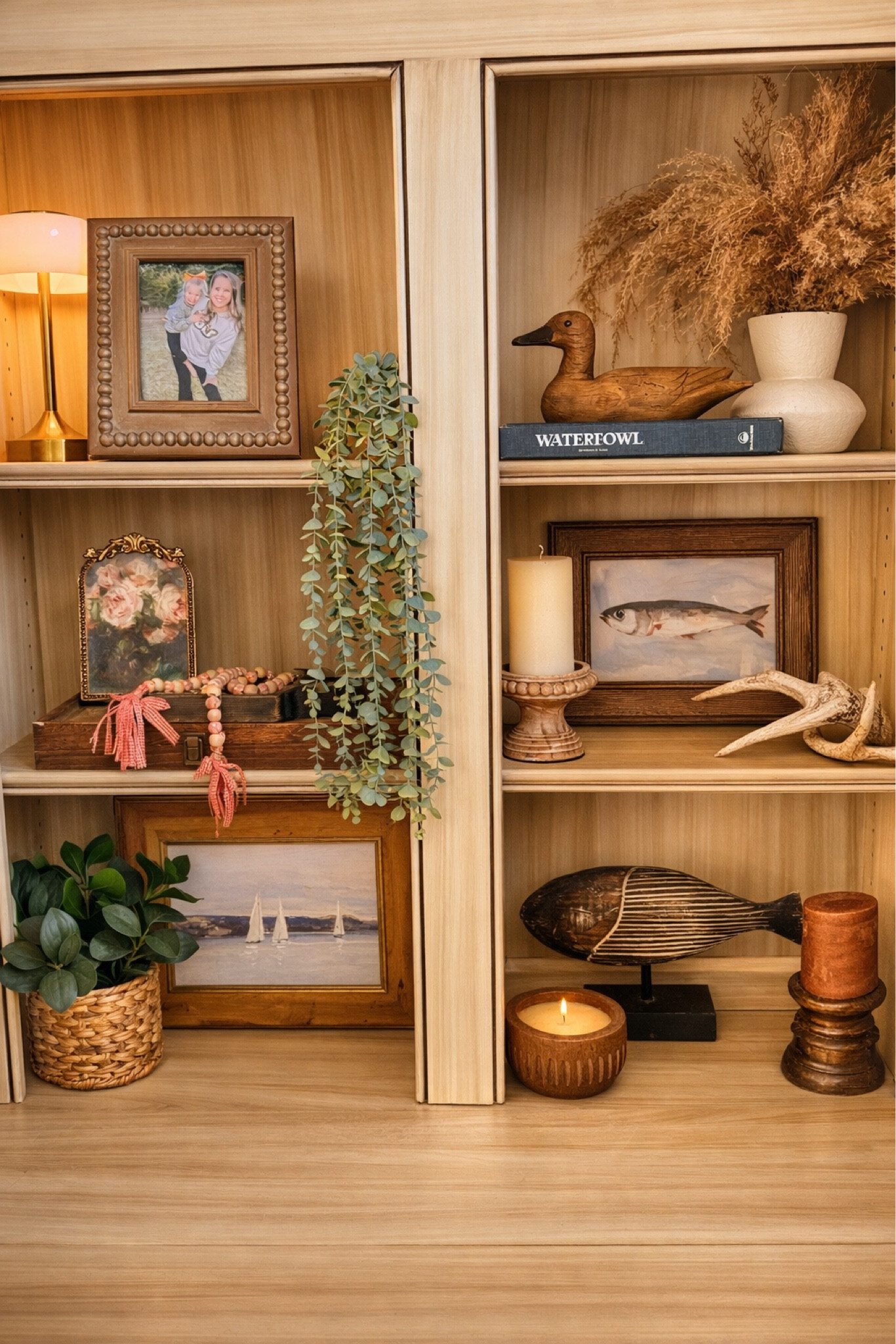 Cozy rustic shelf decor 🤎 Earthy built-in styling with wood accents, greenery, vintage frames, and warm neutral home decor. I'm obsessed with the wooden duck find! #LTKFindsUnder50

#LTKHome