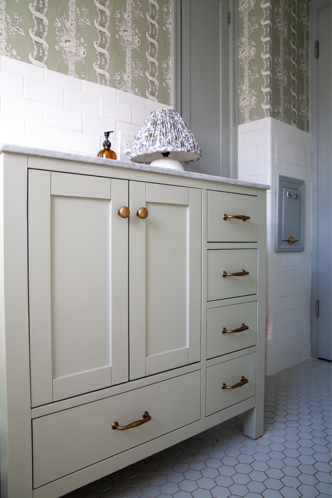 Painted this basic vanity, a color I picked up from the wallpaper and swapped the hardware with these Amazon antique brass ones!

#LTKhome