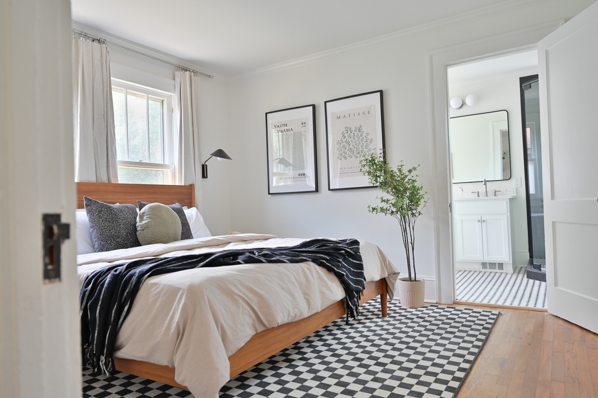 Shop this cozy bedroom I designed for a short term rental. Checkered rug, duvet, mid-century bed, art, sconces, nickel curtain rods

#LTKstyletip #LTKfamily #LTKhome