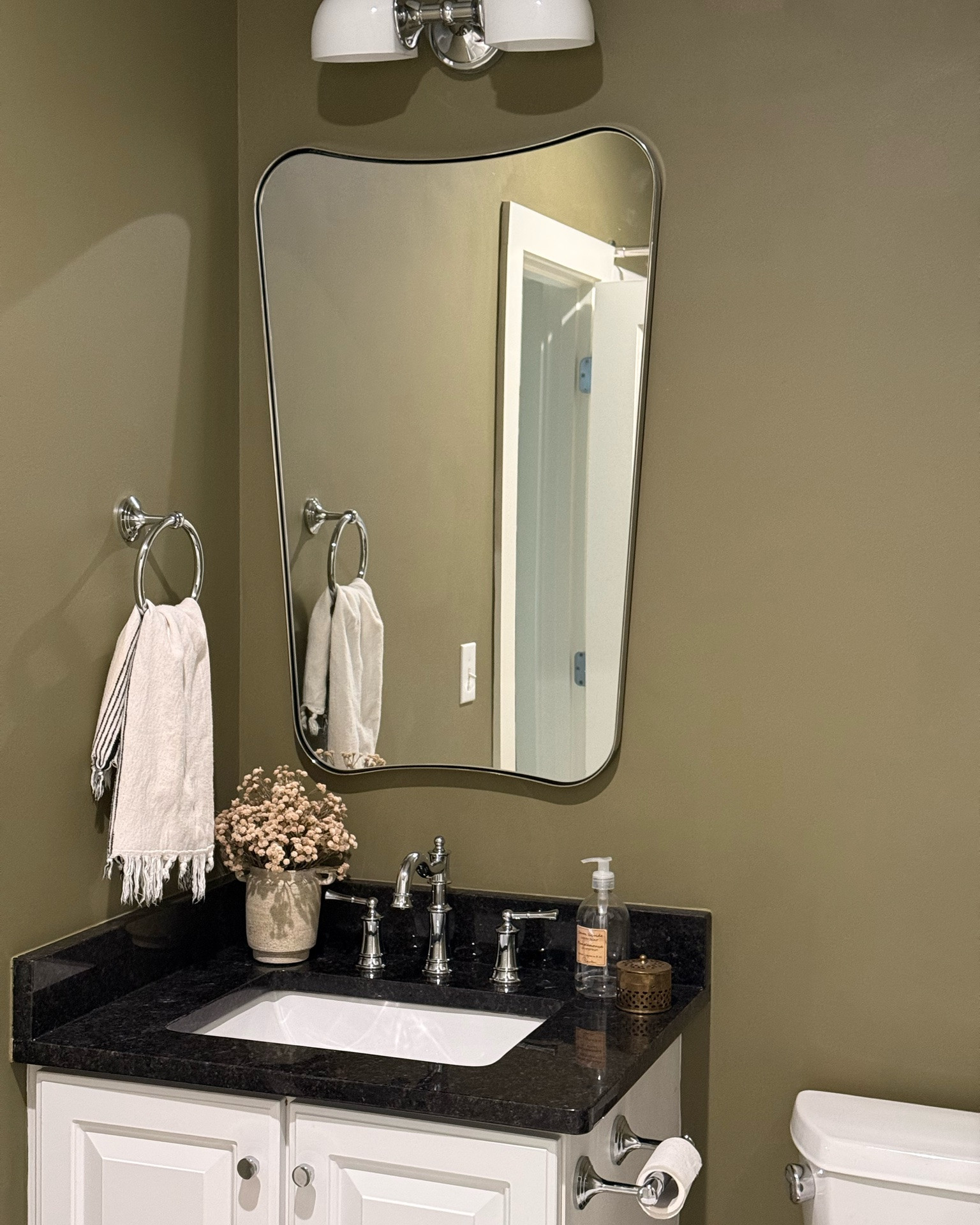 Guest bathroom update, chrome faucet, curved bathroom mirror, bathroom decor