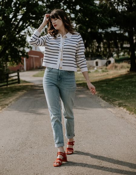 Sezane betty cardigan outfit for spring. Striped cardigan with light wash slim jeans and red sandals  