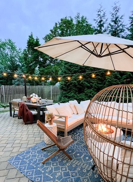 We added string lights and just love how cozy this backyard patio area is! The fire pit and egg chair are perfect for summer nights.

#LTKSeasonal #LTKhome #LTKstyletip