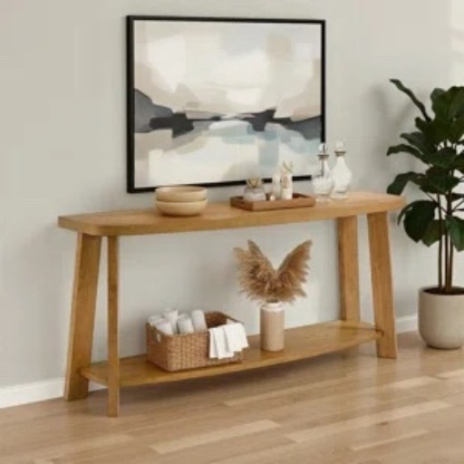This warm wood console table from Wayfair feels like one of those pieces that can make an entryway or living room wall look finished without needing much else. The long top is perfect for a tray, candles, or a few favorite decor pieces, and the lower shelf gives you extra room for baskets and styling. I really like it with the oversized abstract wall art, woven basket, pampas-style stems, and tall leafy plant. I spotted it 5% off at Wayfair.