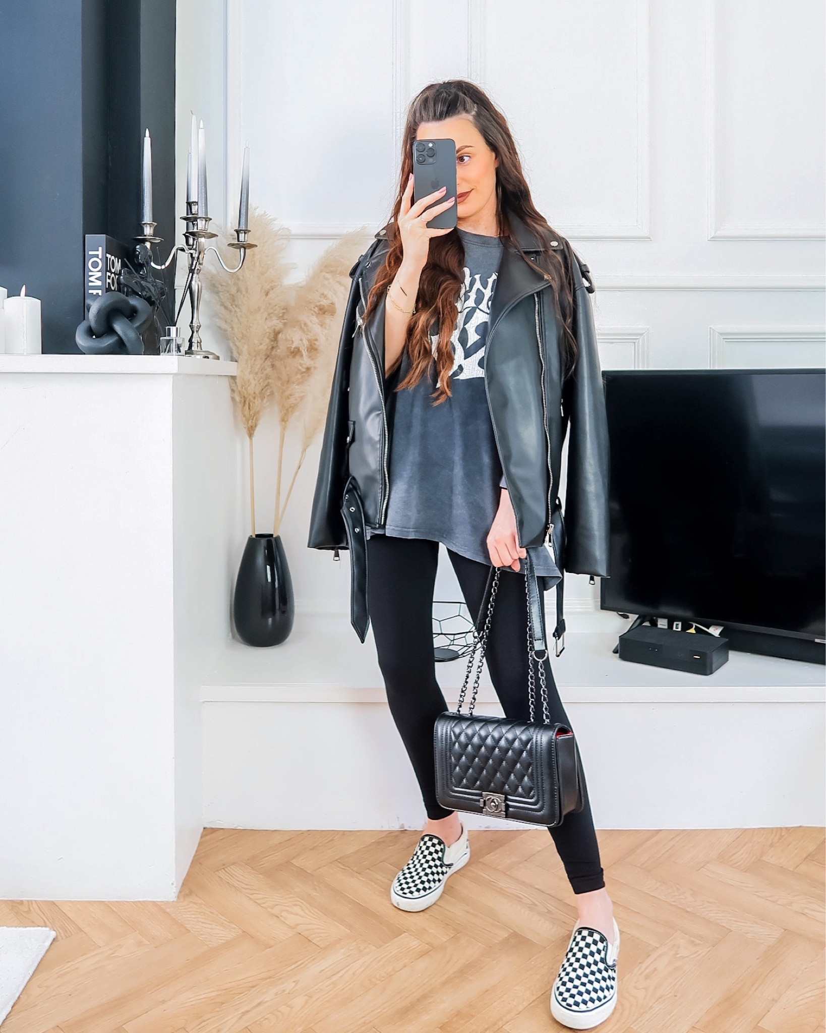 Leggings outfit, high waist black leggings, casual spring outfit, checkerboard vans, slip on vans, blink 182 t shirt, oversized band tee, oversized leather jacket, leather biker jacket 

#LTKstyletip #LTKunder100 #LTKeurope