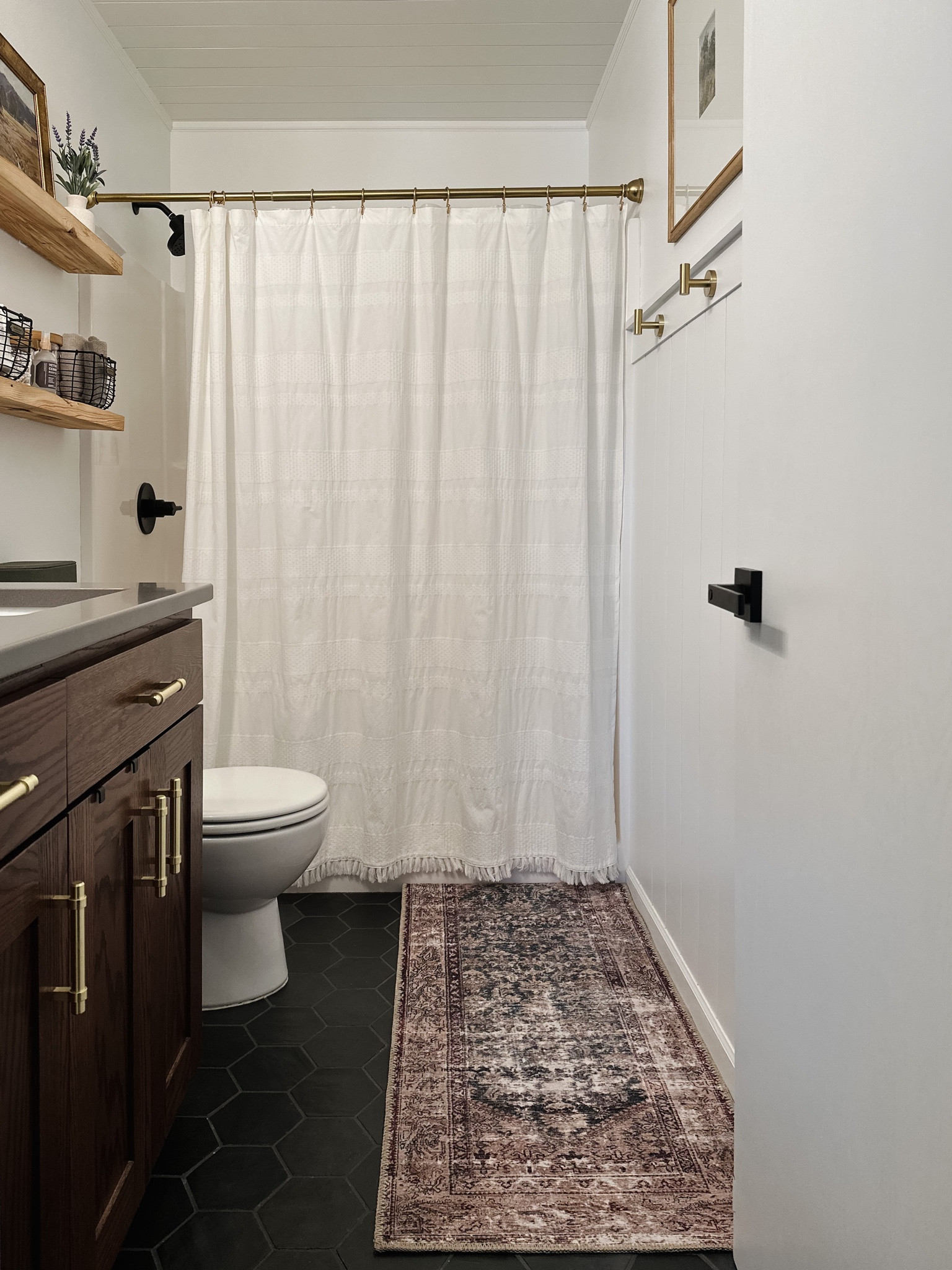 Matte black delta shower fixtures, hearth & hand towel baskets, glass canisters for storage in bathroom, bathroom shelfie, faux lavender, bathroom art, brass shower curtain rod, white shower curtain, wooden shelves, grey quartz countertop, wood picture frame, black lever door hardware, Loloi rug amber Lewis Georgie antique teal, brass cabinet pulls, black basket, brass towel hooks, beau tap bathroom, transitional bathroom, bathroom with shiplap, studio McGee finds, hearth& hand by magnolia finds, target finds, Amazon finds, home decor 

#LTKFind #LTKstyletip #LTKhome