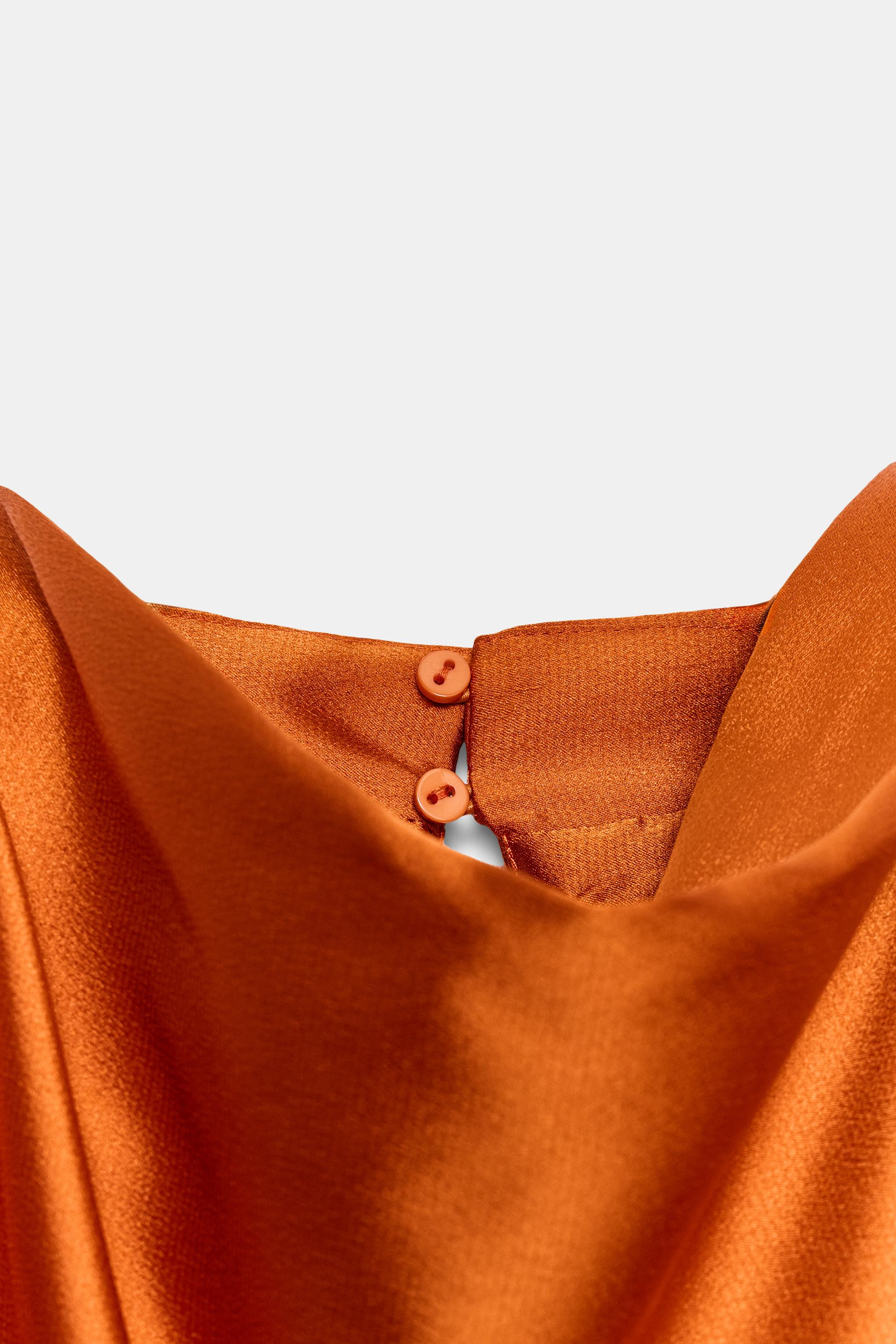 High-neck sleeveless top featuring shoulder pads and pleats. Knot detail at the hem. Back opening... | Zara US