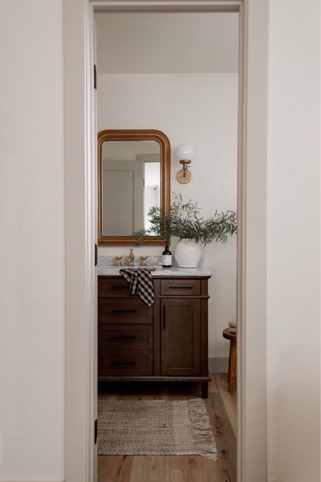 Create a designer look for less in your bathroom with this gorgeous wood vanity (40% off right now!), gold mirror, and bathroom decor.

#sconce #primary #guest #neutral #summer 

#LTKsalealert #LTKfamily #LTKhome