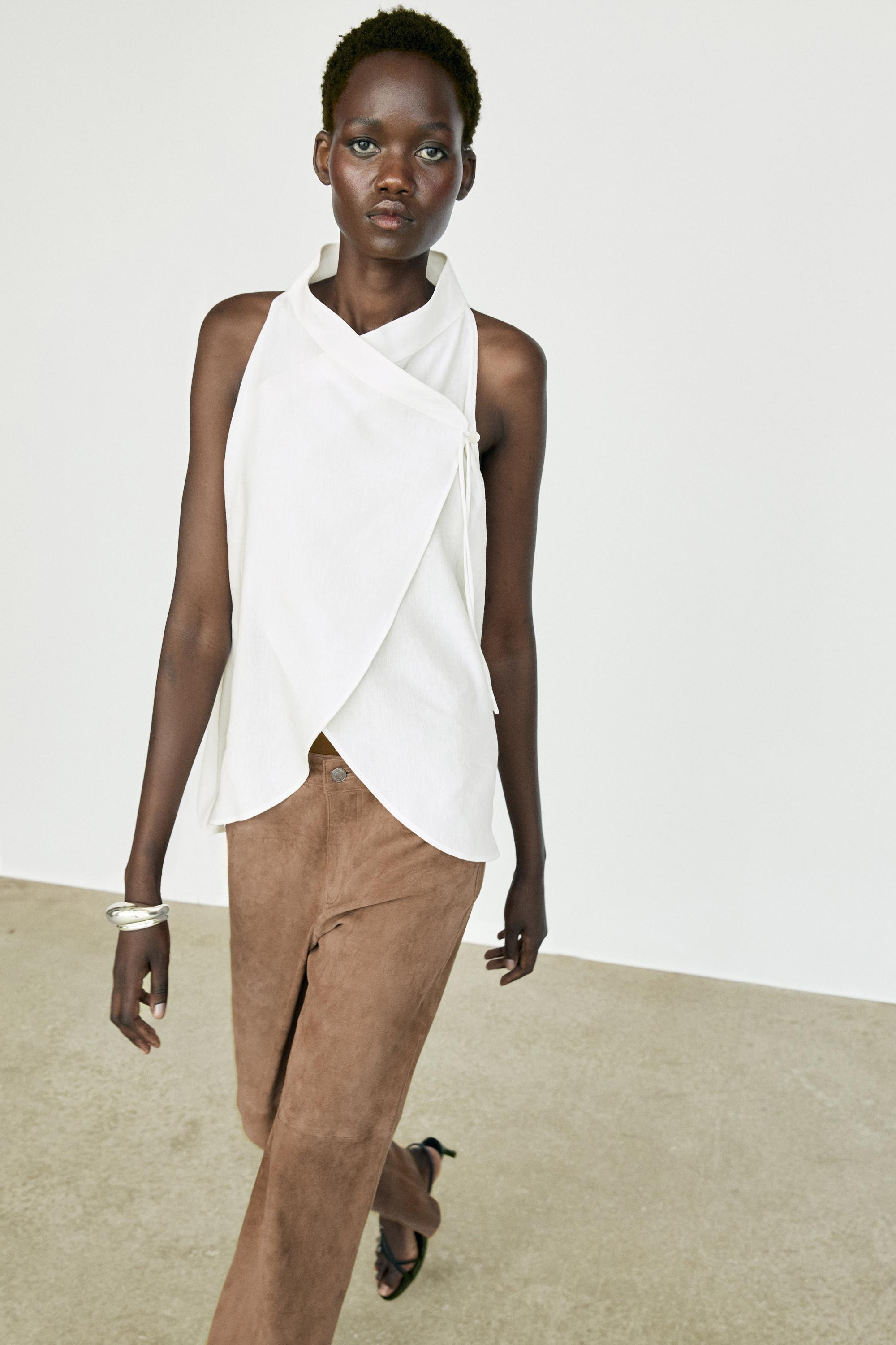 Top crafted from a flowing linen blend fabric. Features a crossover halter neckline and a sleevel... | Massimo Dutti US