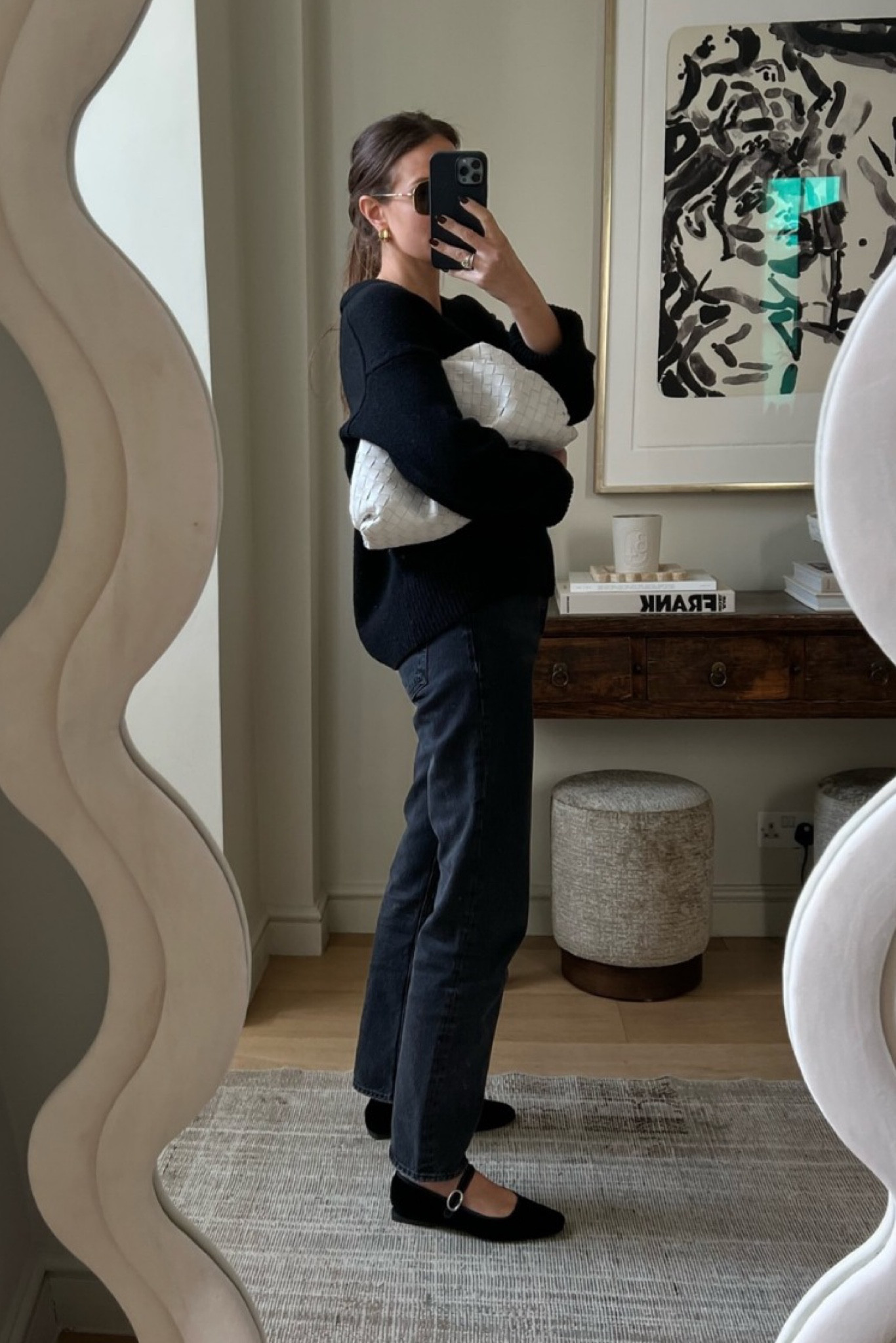 EASY EVERYDAY DRESSING 
Shoes, ZARA
Knit, ARKET (copy of The Row) 
Bag, BOTTEGA VENETA 

For those days when you’re on the go -  you’re flying straight out door for the school run and then bouncing all over town for meetings/errands, you need to feel comfortable and still look smart AND be ready for whatever the London sky throws at you! 🌧️ Here I’m wearing a simple off-white tee under the knit, a relaxed straight-ish jean shape but the dark wash keeps it smart. 

City style, london street style, laid back look, weekday uniform, black knitwear, black jumper, Mary Jane flats, t-bar shoes, velvet flats, velvet slippers, straight leg jean, cloud clutch, white cuddle clutch, woven leather pouch, woven leather bag, oversized clutch, unpredictable weather look. 

#RILEYUGGLA 

#LTKeurope #LTKSeasonal #LTKworkwear