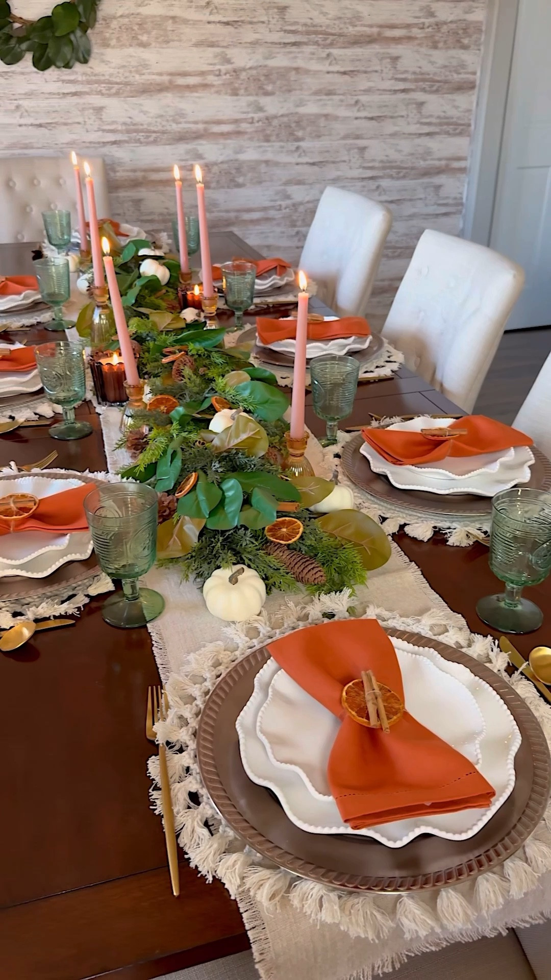 Thanksgiving Table Inspiration with Orange slices, pinecones, magnolia leaves and more.
