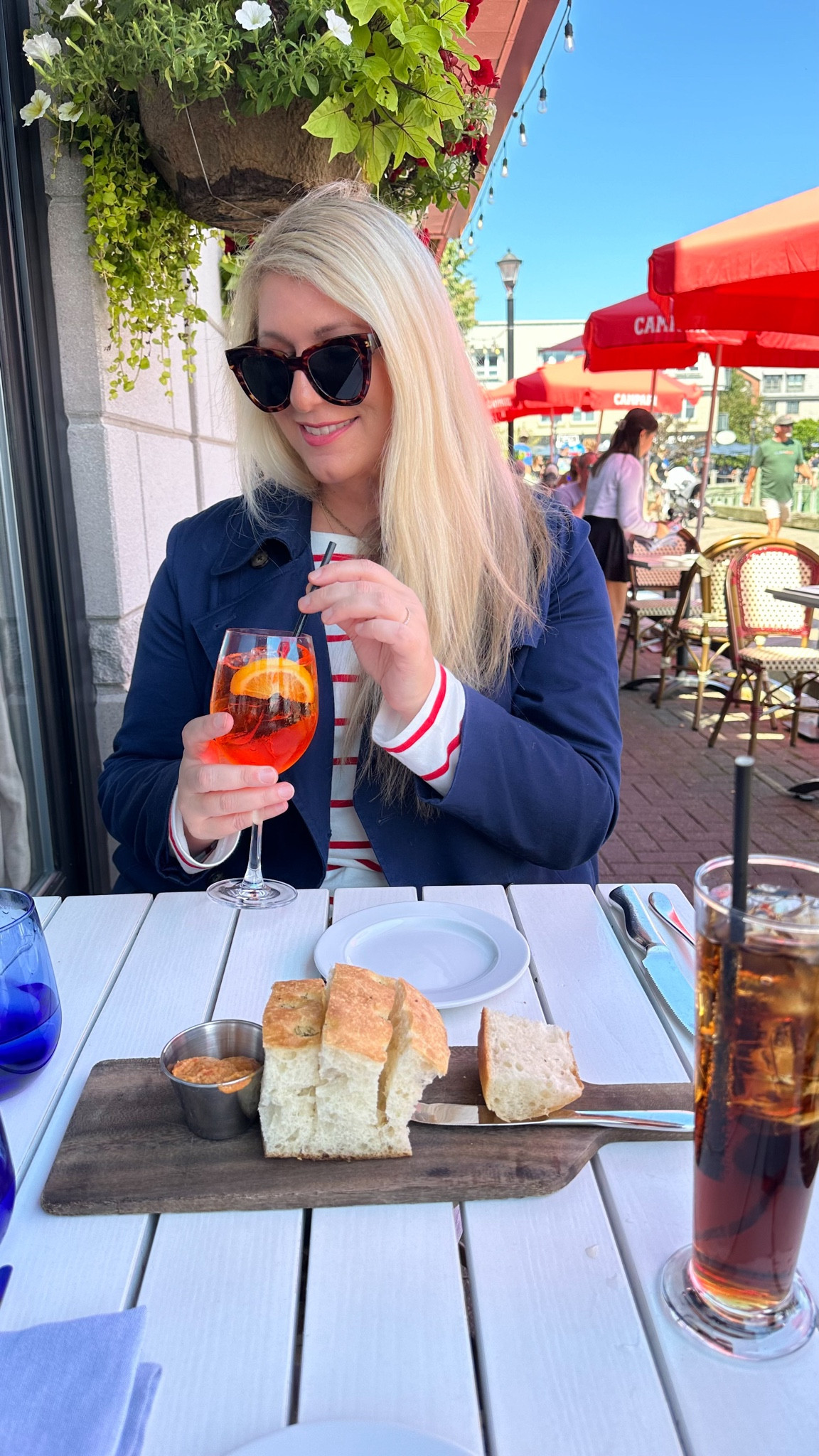 Hi from Nova Scotia! Enjoying our last travel of summer. Red & white striped shirt, navy trench coat, and my favorite sunglasses 🕶️ 

#LTKOver40 #LTKFindsUnder50 #LTKSaleAlert