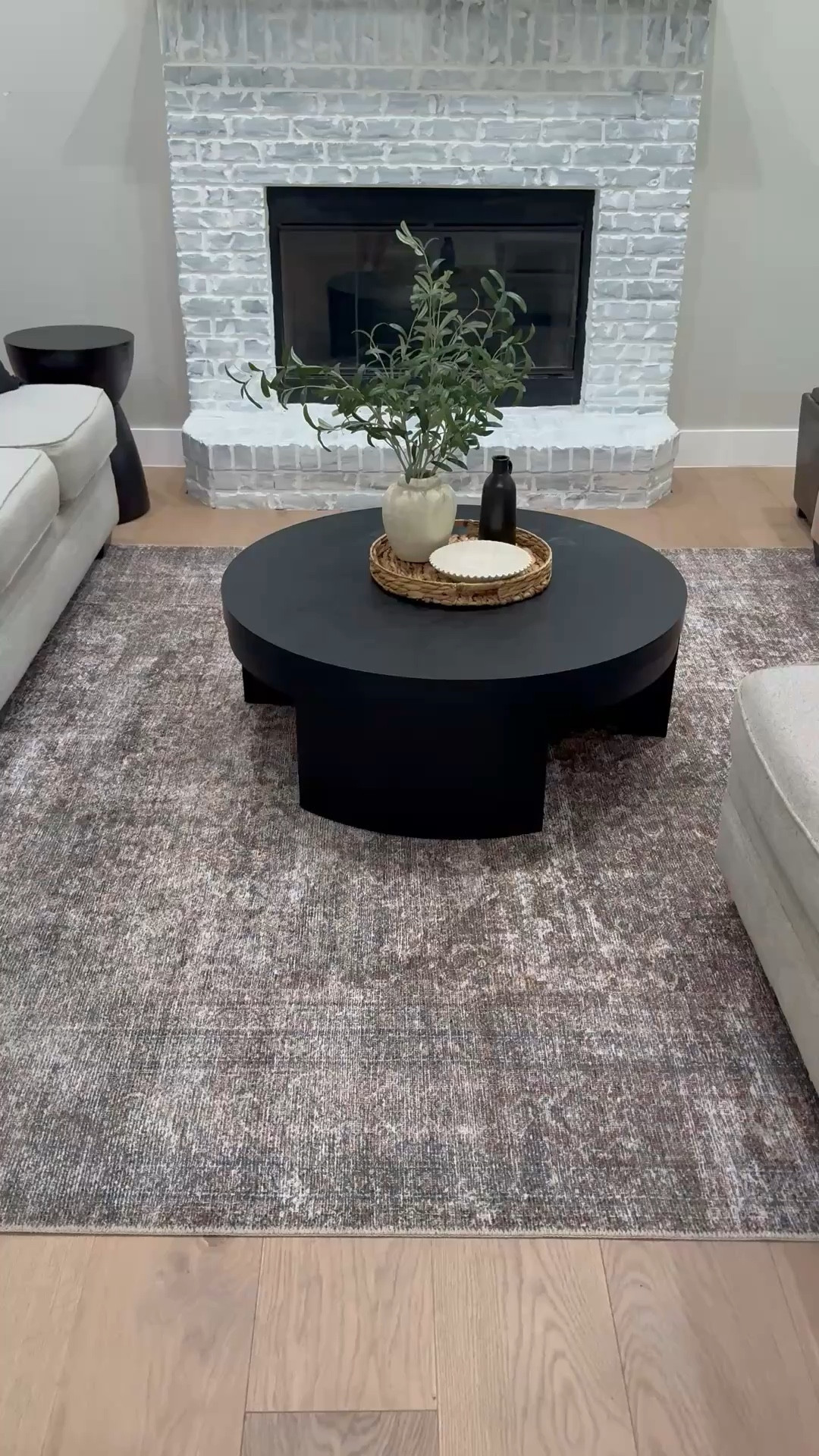 Love this neutral area rug and black round coffee table.   Home decor, living room decor 

#LTKdayinmylife #LTKvlog #LTKHome