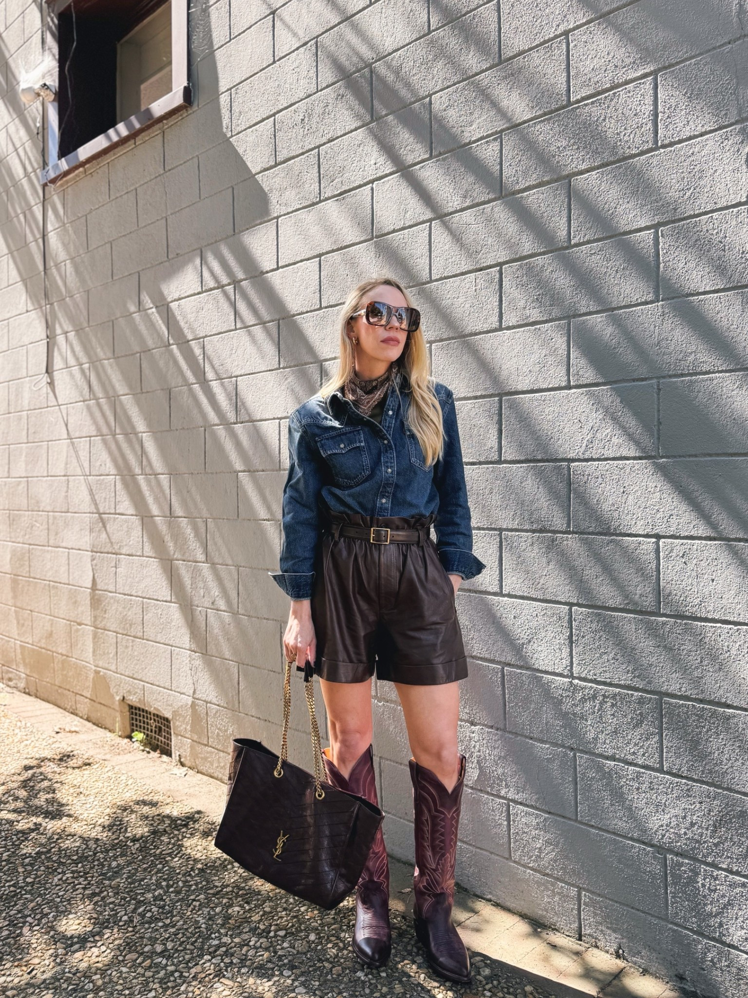 Fall western outfit, @levi shoulder pad denim shirt, paisley silk scarf, brown leather shorts, @Tecovas burgundy cowboy boots

#LTKSeasonal #LTKSaleAlert #LTKOver40