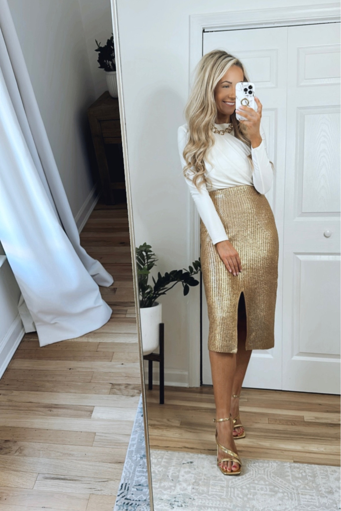 Holiday party outfit! 

This metallic skirt is made of a stretchy sweater material (runs TTS), this off white top has a pretty crossover detail in the front and shoulder pads (so chic!), I added a chunky gold chain and gold strappy sandals to complete the holiday party look!

#LTKHoliday