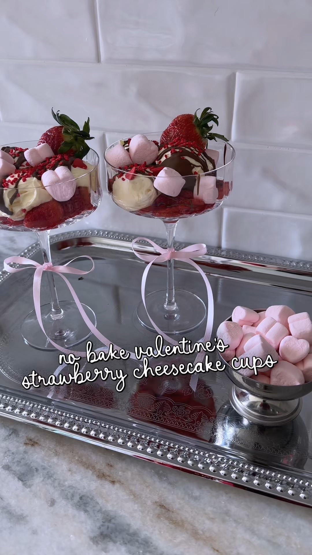 no-bake valentine’s strawberry cheesecake cups 🍓

Exact steps 🍓

– slice strawberries into little heart shapes
– add a few scoops of cheesecake dip
– sprinkle in heart marshmallows
– melt a chocolate bar in hot water
– snip the corner and drizzle on top
– finish with heart sprinkles

So easy and looks way fancier than it is ✨

Such an easy valentine’s dessert idea using simple ingredients layered in a coupe or champagne glass. perfect for galentine’s, date night, or a small valentine’s get-together. no baking required and done in minutes. linking the glasses, ribbon, and serving pieces here.

valentine’s dessert, no bake dessert, galentine’s ideas, valentine’s hosting, strawberry cheesecake, easy desserts, champagne coupes, valentine’s party

#LTKfoodie #LTKValentine #LTKSeasonal