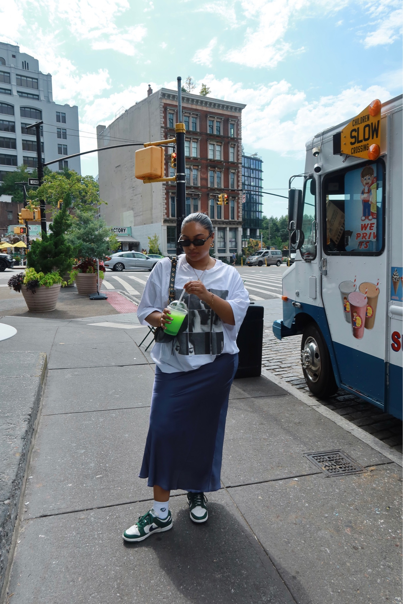 Fall fashion, autumn wardrobe, transitional outfit, oversized tee, white tee, graphic tee, satin skirt, navy skirt, midi skirt, black sunglasses, rectangle sunglasses, ribbed socks, white socks, green and white trainers, low trainers, low dunks, Nike, ASOS, Le Specs, New Look, Urban Outfitters, M&S, New Balance, 550s, Pull & Bear

#LTKstyletip #LTKSeasonal #LTKeurope
