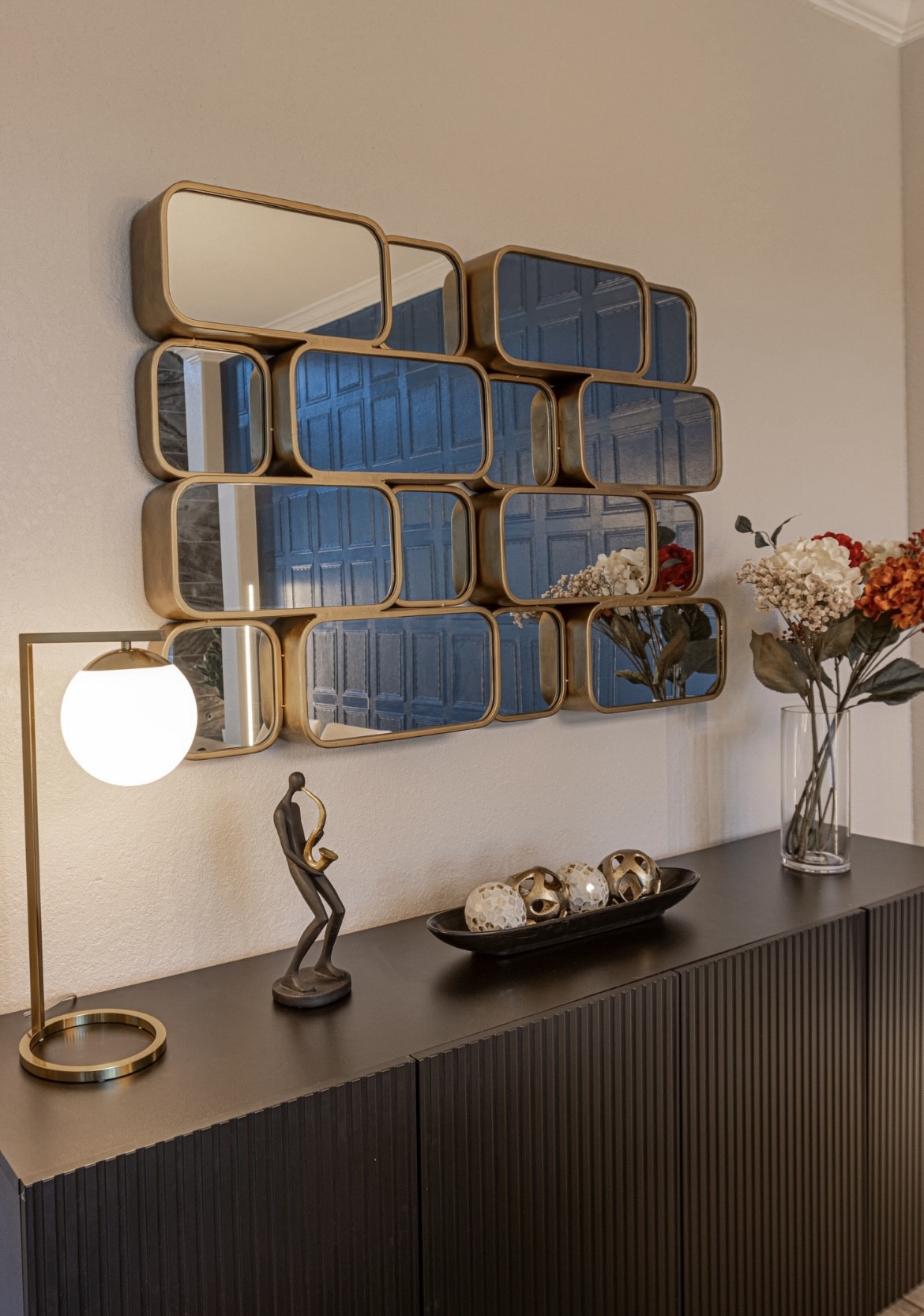 Styling tips: sideboard decoration using this unique mirror and table lamp on top of a black sideboard 

#LTKhome