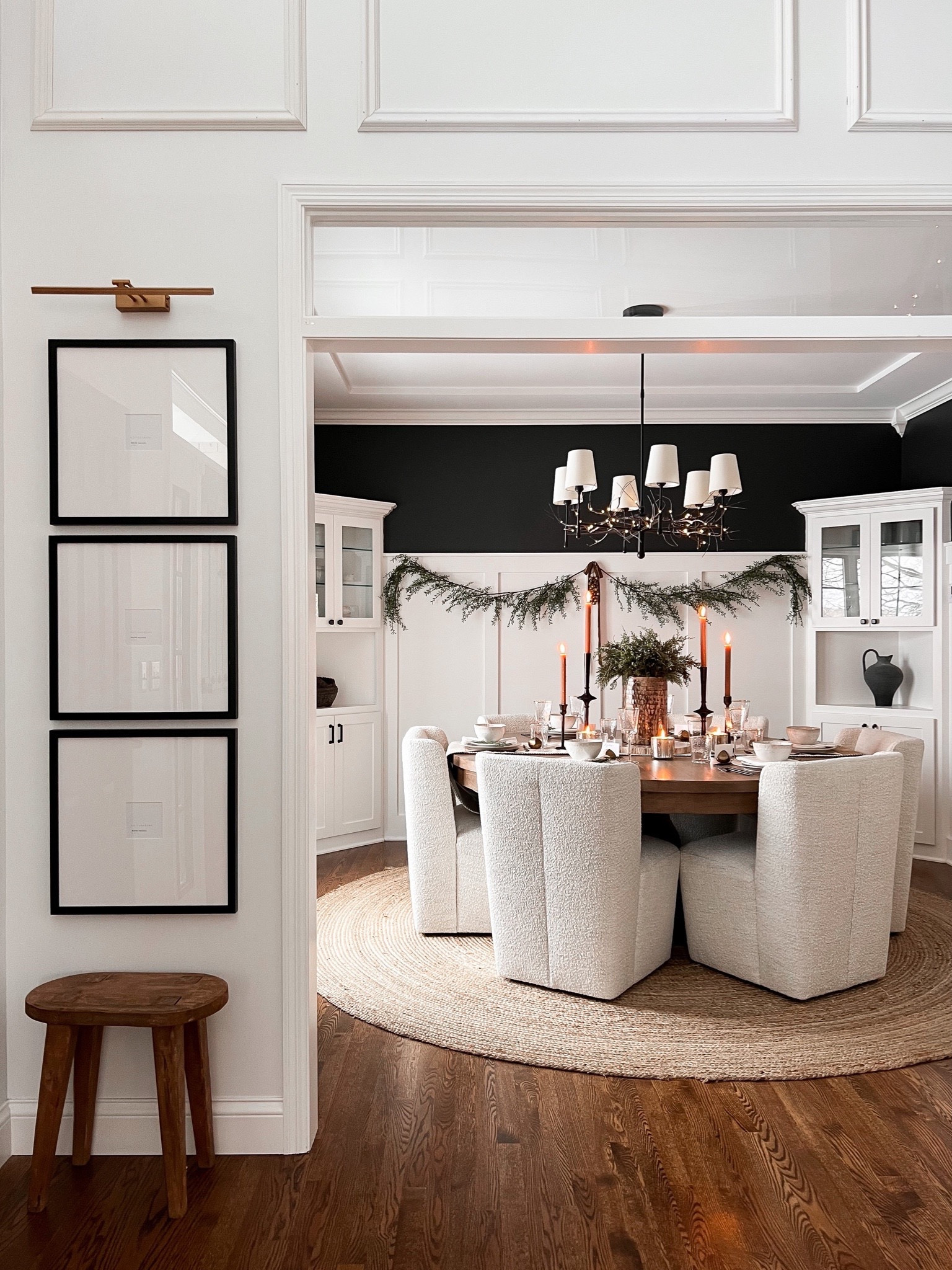 Dining room with round table and upholstered chairs, round jute rug, chandelier for round dining table, square gallery frames, rechargeable picture frame light, rugs USA 

#LTKhome #LTKstyletip