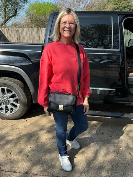 Cute travel day or errands outfit - XS crewneck with cute detail sleeve 50% off now, M stretchy denim, crossbody purse, and trendy designer look alike sneakers 

#LTKsalealert #LTKitbag #LTKover40
