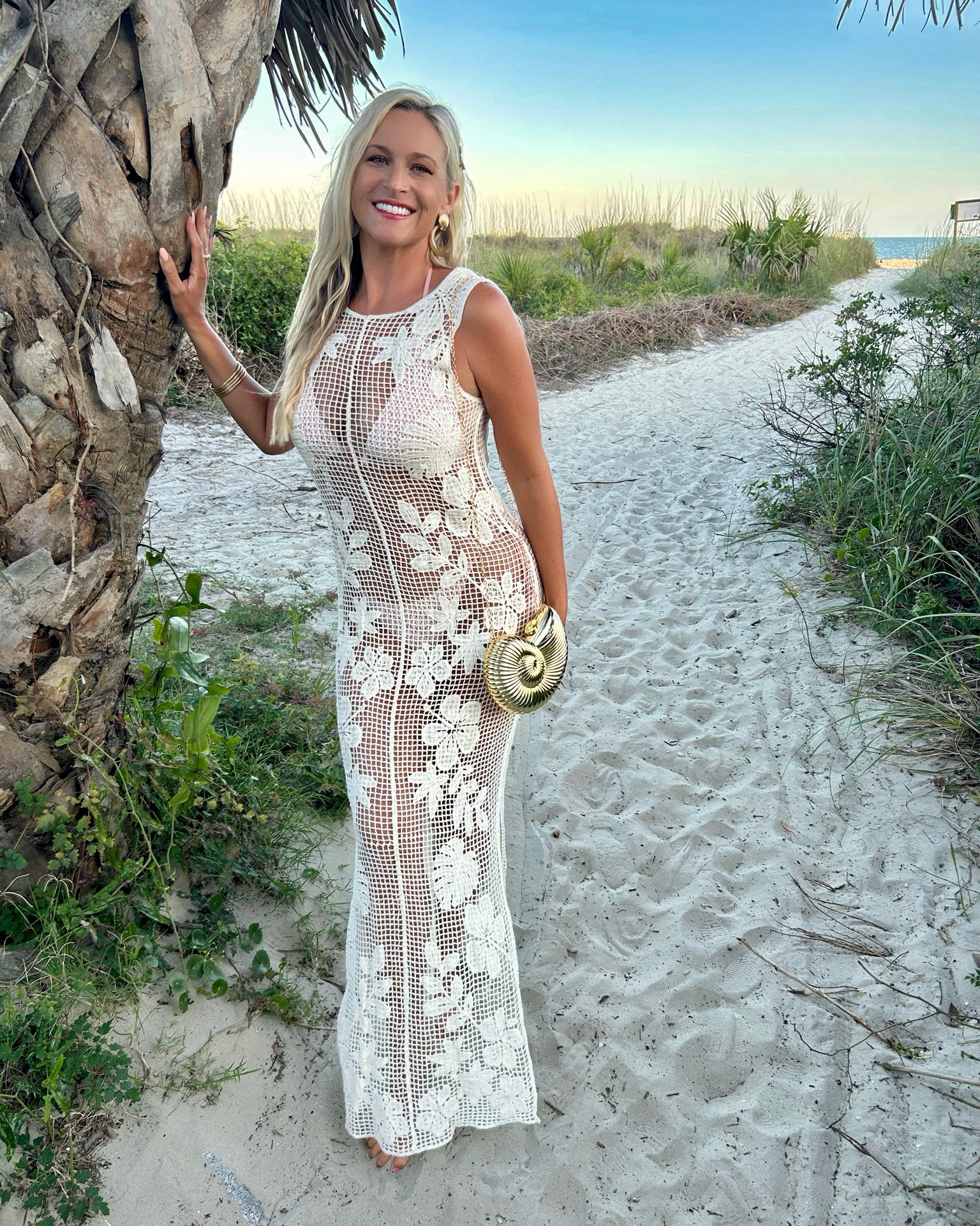The soft crochet fabric, the gorgeous drape, the open-back detail, and this statement gold shell purse create the perfect blend of coastal charm and resort elegance. Sometimes the prettiest pieces simply can’t be captured in a single photo. 🤍🐚

#LTKootd #LTKTravel #LTKSwim