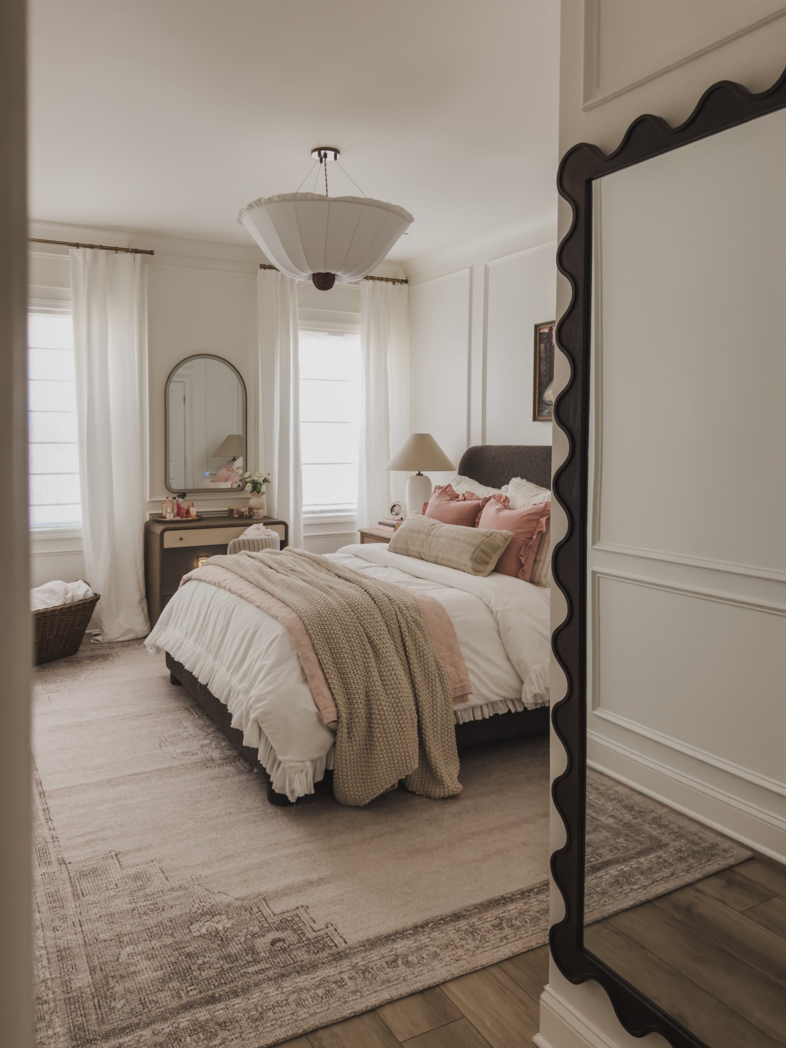 Light and airy teen bedroom with the sweetest pops of pink. Emma had three must-
 haves: her kitty (you’ll spot photos styled throughout), pink tones, and all the ruffles— so we leaned into that while still keeping the space timeless.

When designing a room for a growing teen, I always think about pieces that can evolve with them. We chose a slightly moodier upholstered bed that will hold up to everyday life (and the inevitable makeup phase), while still feeling soft and elevated layered with ruffles and cozy textiles.

One of my favorite details is the desk moment doubling as a vanity. The mirror has built in LED lighting around the frame, which makes it just as functional as it is pretty. Perfect for getting ready, studying, and everything in between. Paired with the striped chair, it adds just enough personality without overwhelming the space!

A mix of quality staples with a few playful accents makes this a room she can grow into, not out of.

Pottery barn style, home inspo, teen girl bedroom, neutral home, wayfair furniture finds, home and kids co, Anthropologie home finds, curtain details, shop the look! 

#LTKSaleAlert #LTKKids #LTKHome