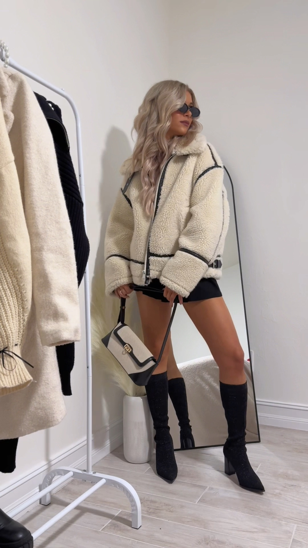 Zara Sherpa jacket, biker jacket, fuzzy coat, women’s winter coat, winter fashion, two toned bag, beige and black purse, trendy handbag, retro black sunglasses, oval sunglasses, NEWBELLA boots, glitter knee high boots, chunky knit boots, black heeled boots, flower earrings, pearl earrings, gold jewelry, black strapless romper, black casual dress

#LTKVideo #LTKSeasonal #LTKshoecrush