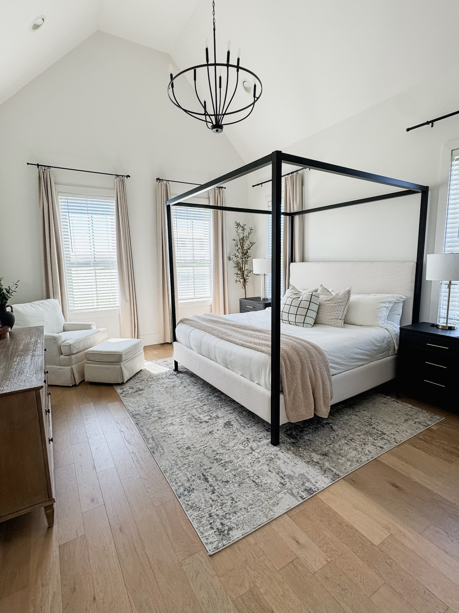 Primary Bedroom Furniture, Pottery barn atwell canopy bed dupe from wayfair, white linen nursery chair, cream swivel glider, White linen bedding, chenille blanket, faux tree plant, nightstand lamp, nuetral bedroom rug, area rug, modern primary bedroom furniture, accent pillows, white and gold table lamp, natural wood  bedroom dresser, white / cream bedroom accent chair, bedroom curtains 

#LTKHome