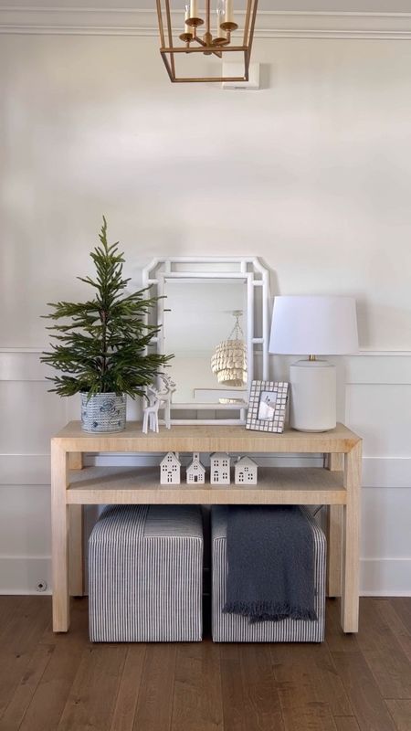 Coastal entryway decor. This vase is currently sold old but I’ve linked a couple similar ones from Cailini Coastal! 

My console table and mirror and both 25% off right now! 

Holiday entryway, coastal Christmas, Norfolk pine tree, Christmas houses, white reindeer, blue and white decor 
