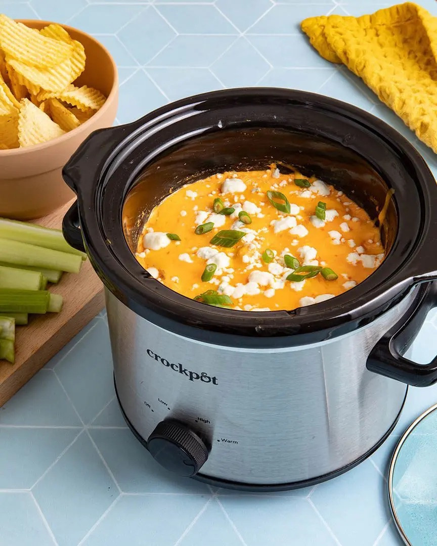 Buffalo chicken dip is a classic app. This super easy big-batch version is perfect for parties because you can keep it warm and delicious for hours! Plus all you have to do is combine the ingredients in a crock pot and pretty much forget about it for an hour or 2. Multi-tasking anyone? 